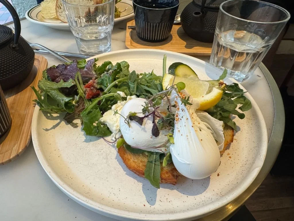 Poached eggs on toast at Tomo Little Collins, Melbourne