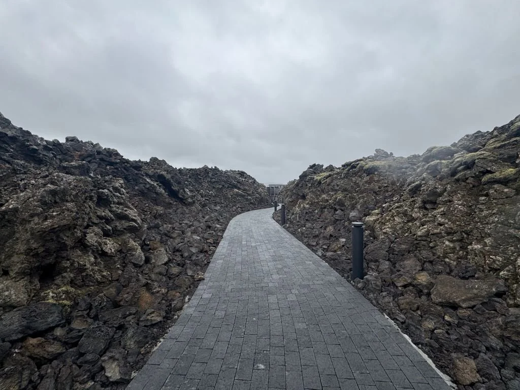 The walk from the drop-off point to the Blue Lagoon entrance is a pathway surrounded by black volcanic rock