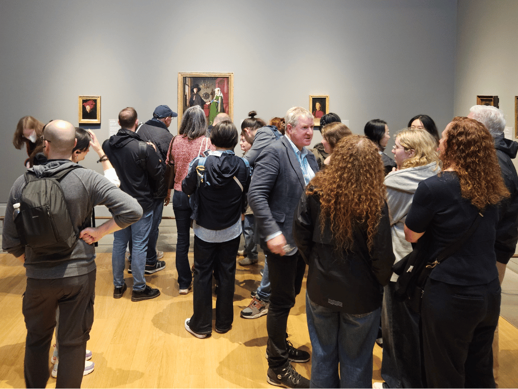 Crowds looking at van Eyck's The Arnolfini Portrait at National Gallery, London