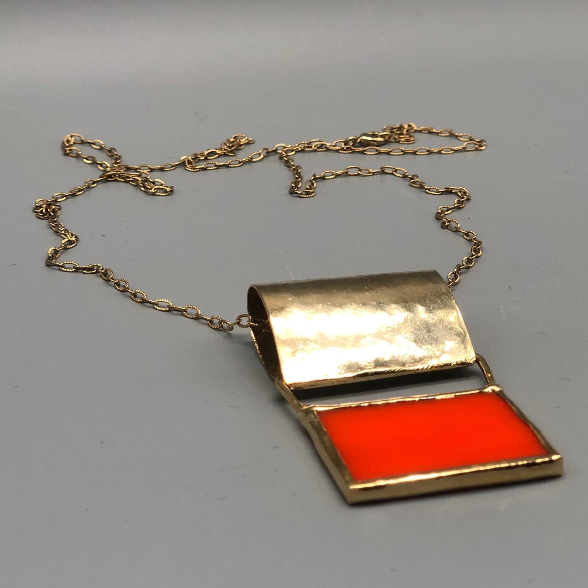 Anni Luce pendant necklace in gold-toned metal with red glass insert, contemporary jewelry Crepundia Gioielli Bologna
Collana con pendente Anni Luce in metallo dorato con inserto rettangolare in vetro rosso, gioielli contemporanei Crepundia Gioielli 