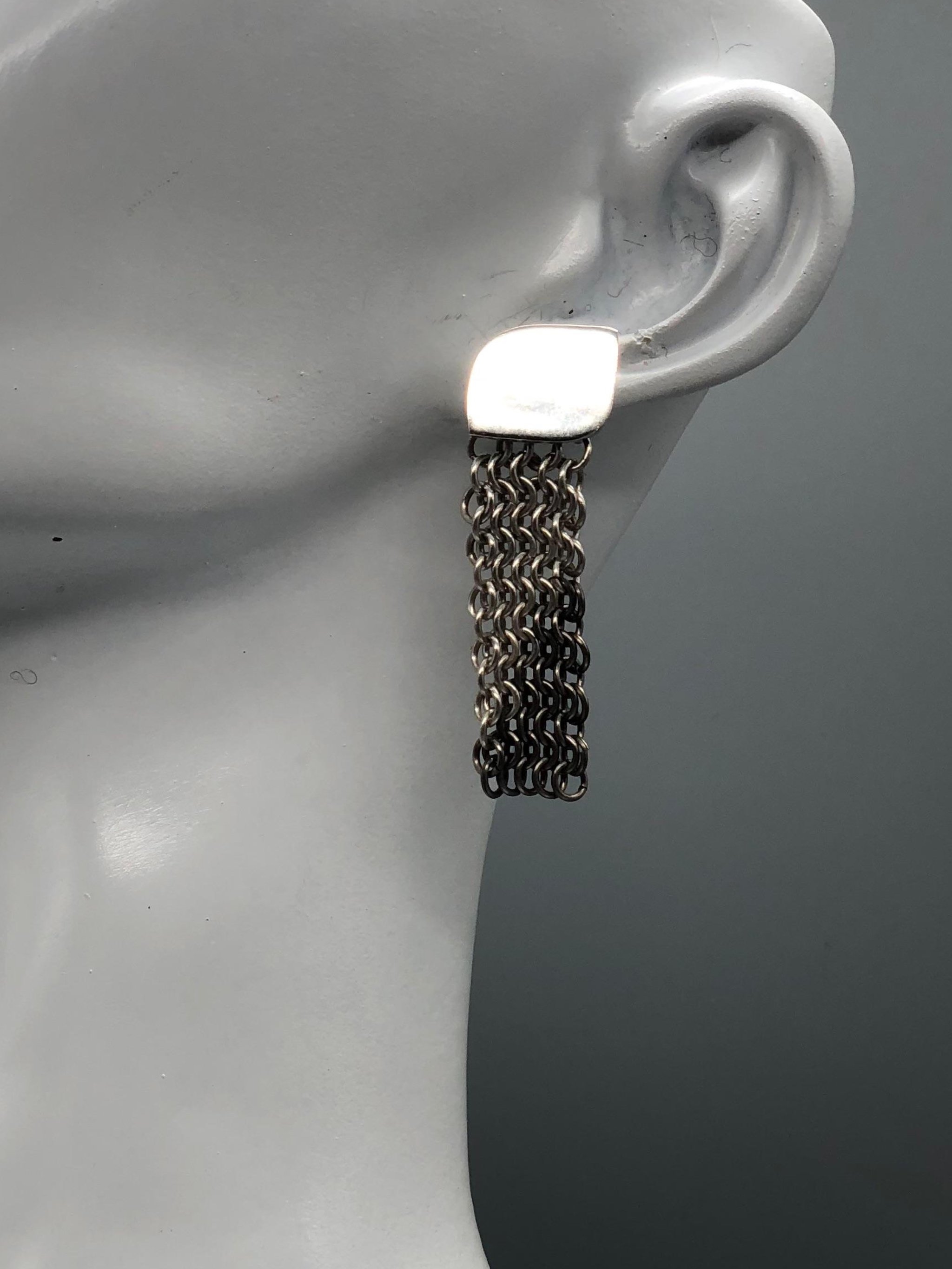 Sterling silver and titanium mesh earrings by Ariadna Segafredo for Crepundia Gioielli, featuring handcrafted woven titanium links and a minimalist silver top.