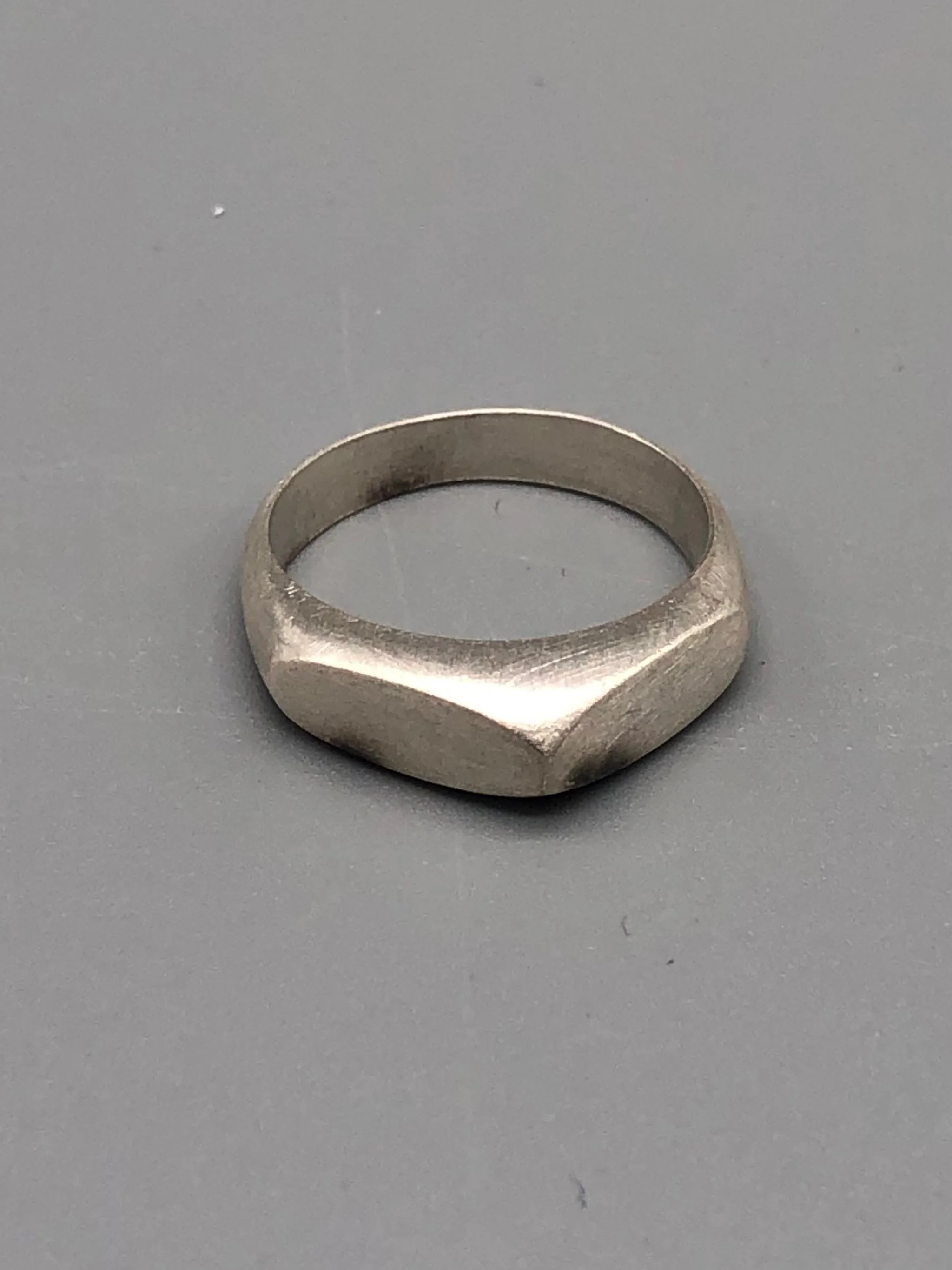 Tre anelli Cuspide di Crepundia Gioielli in argento, argento brunito e bronzo, sovrapposti in una composizione geometrica e scultorea.  Three Crepundia Cuspide rings in sterling silver, oxidized silve