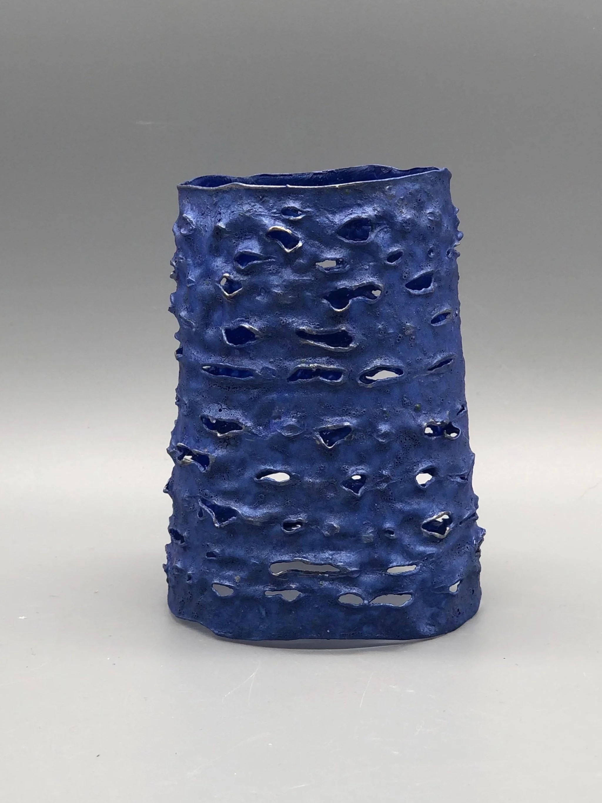 Trama Blue Metal bracelet by Giovanna Ussani, made from layered recycled plastic with perforated surface and metallic blue pigment.