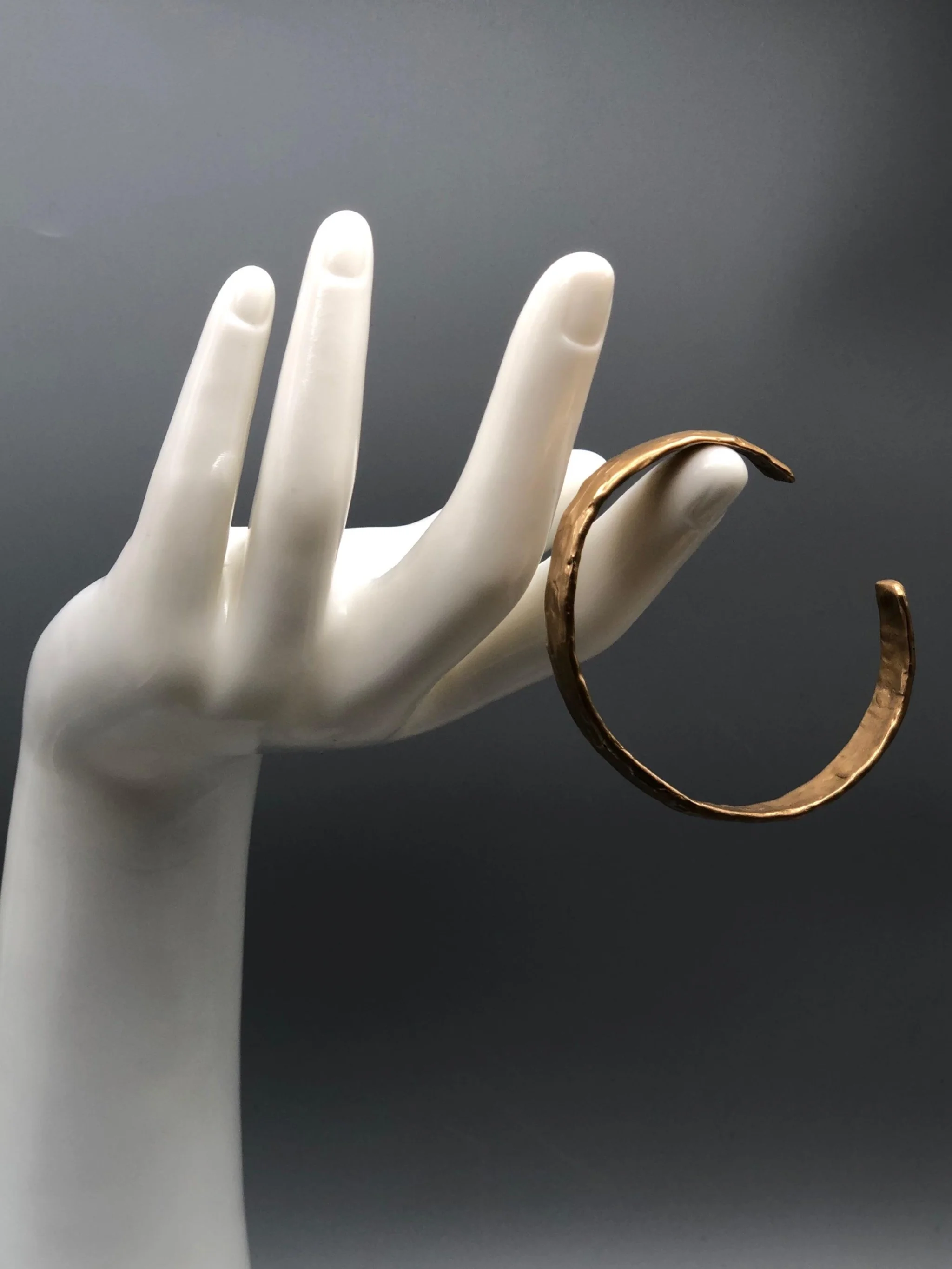 Handmade bronze cuff bracelet with textured sculptural surface by Floret Gioielli