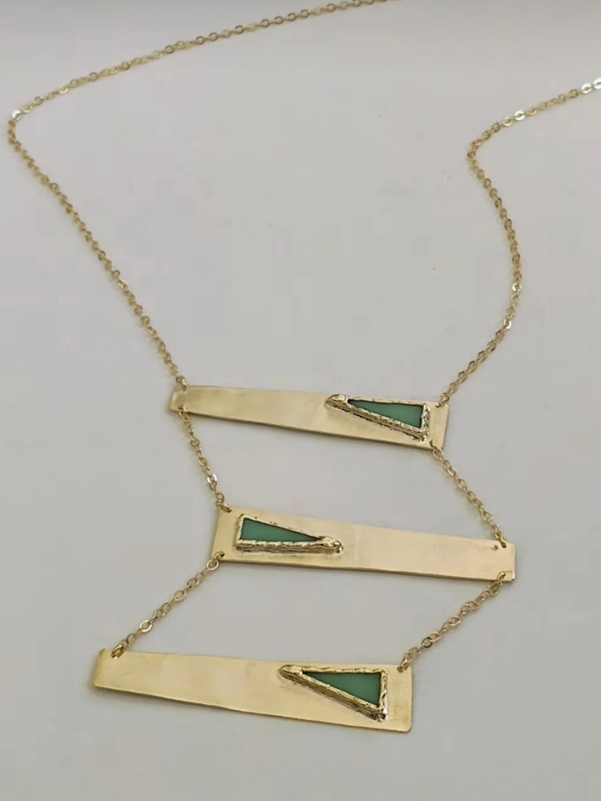 Contemporary rectangular necklace by Anni Luce in gold-plated metal with mint green enamel detail, Crepundia Gioielli Bologna