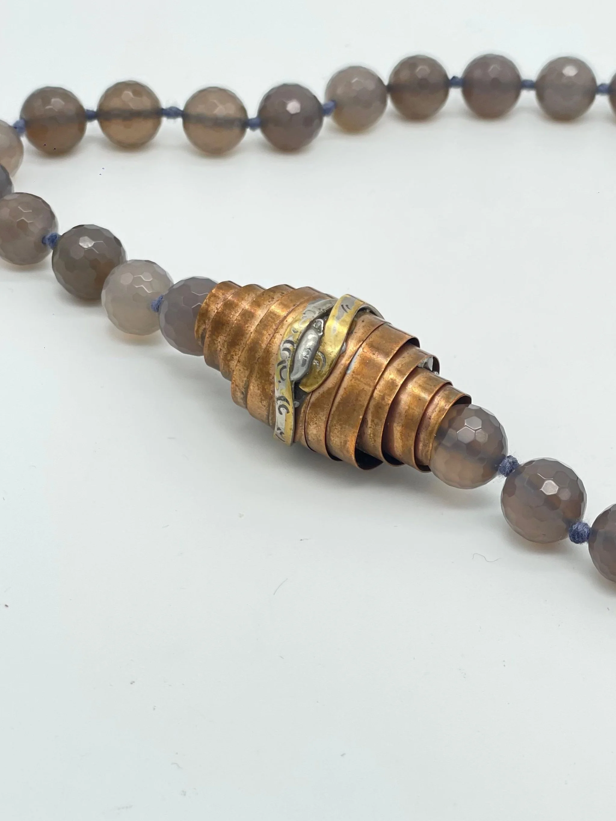 Faceted grey agate necklace with sculptural bronze and silver element by Padma — Crepundia Gioielli Bologna