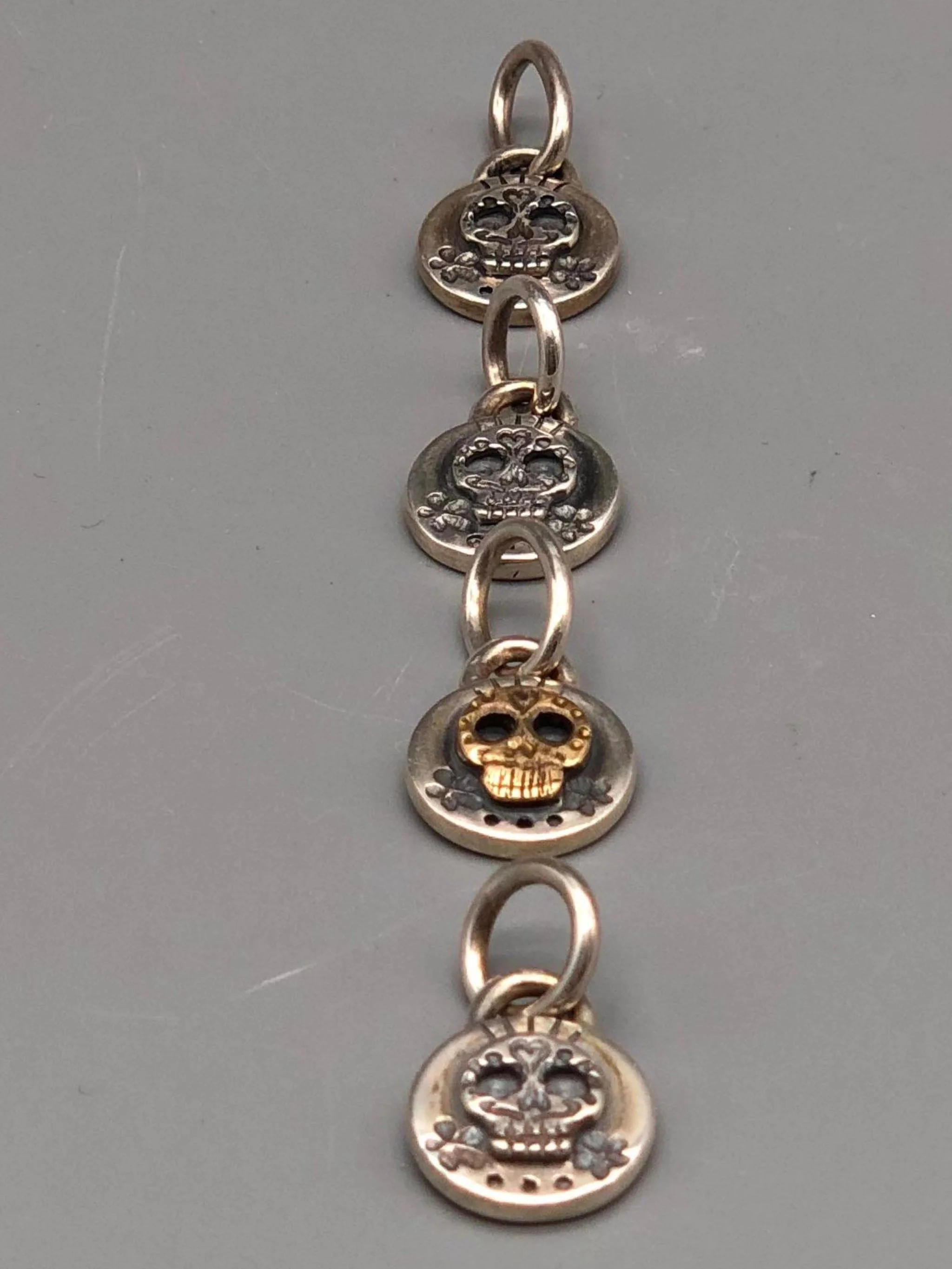 Sonja Markhoff Calavera pendants for Crepundia Gioielli Bologna in matte sterling silver, available with or without 18 kt gold detail