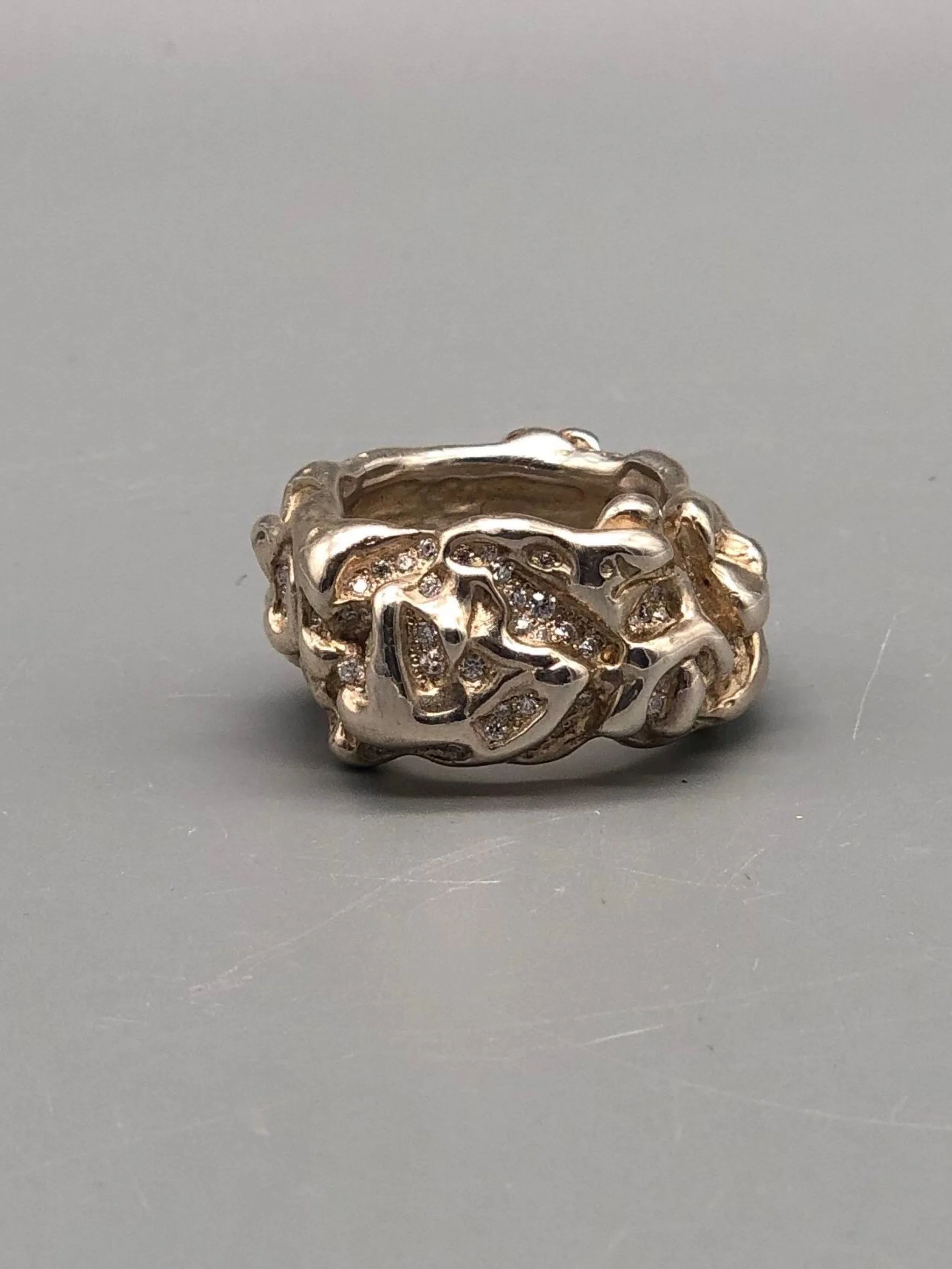Portas Jewels Skinwalker ring set with 142 moissanites, featuring an intricate organic surface and sculptural silver band.