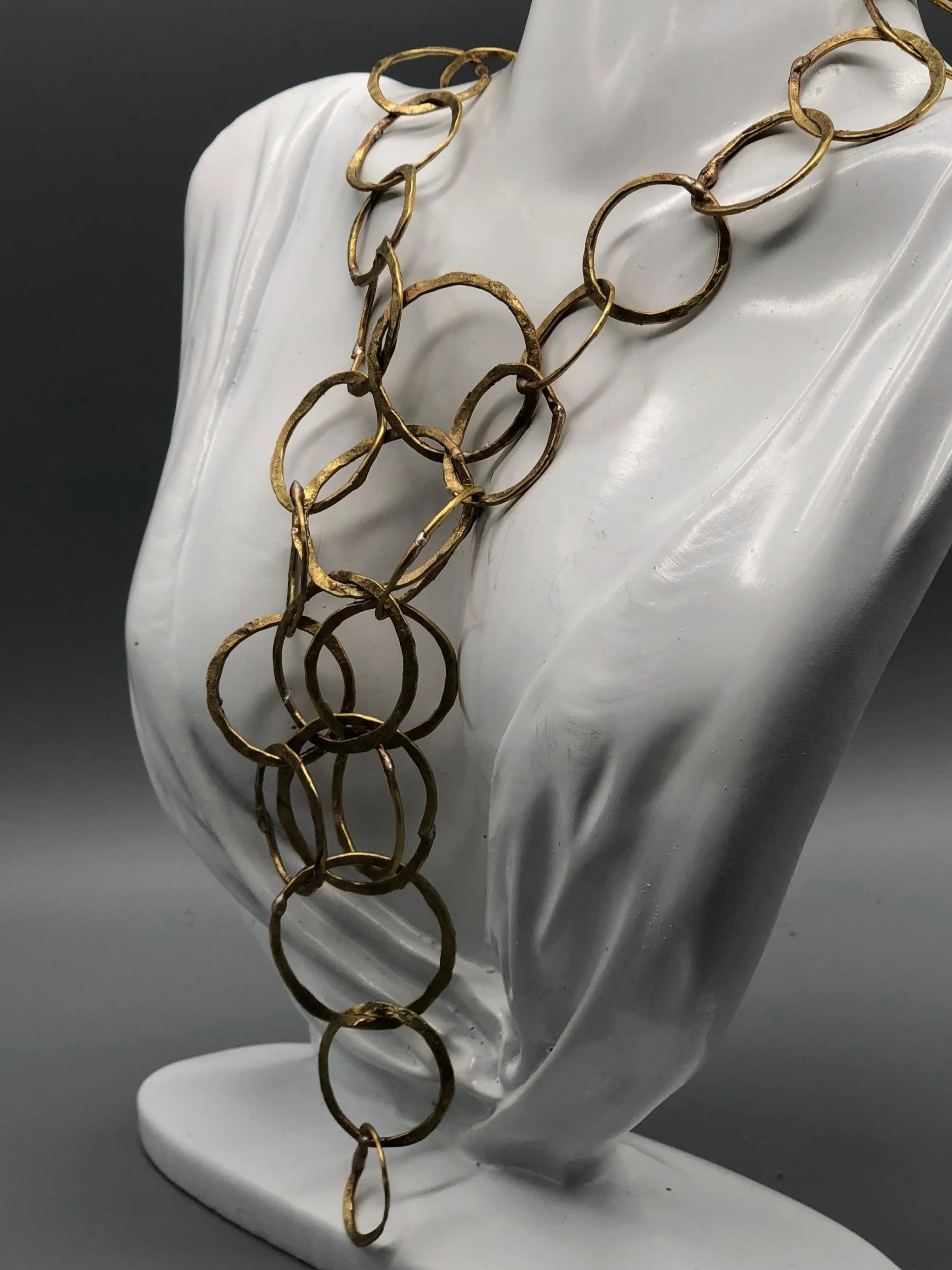 Collana Full Outline di Claudia Cuzzeri in ottone opaco, con maglie irregolari sovrapposte e struttura centrale ampia e articolata.