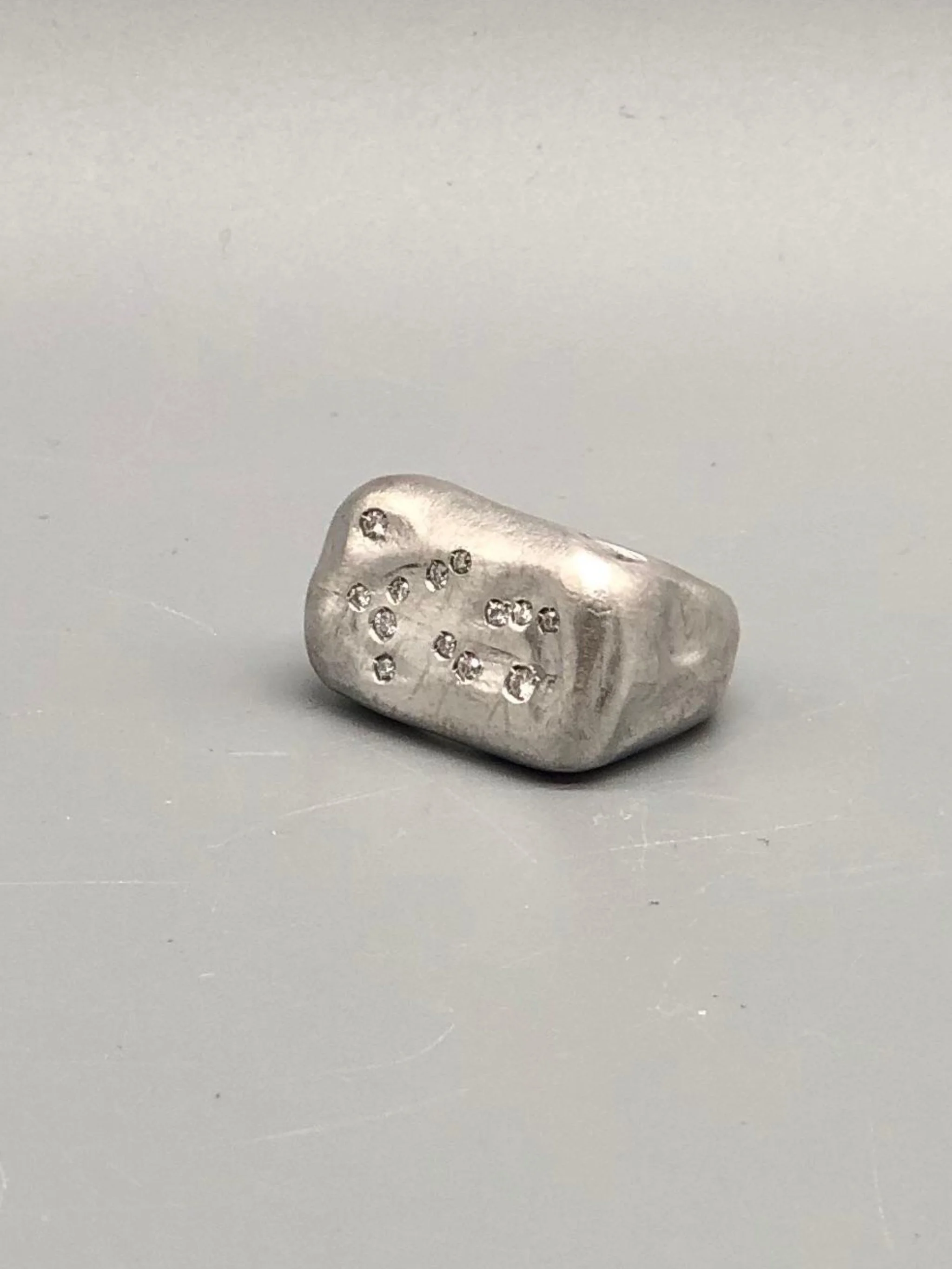 Crepundia Gioielli matte silver Echo ring with diamonds.