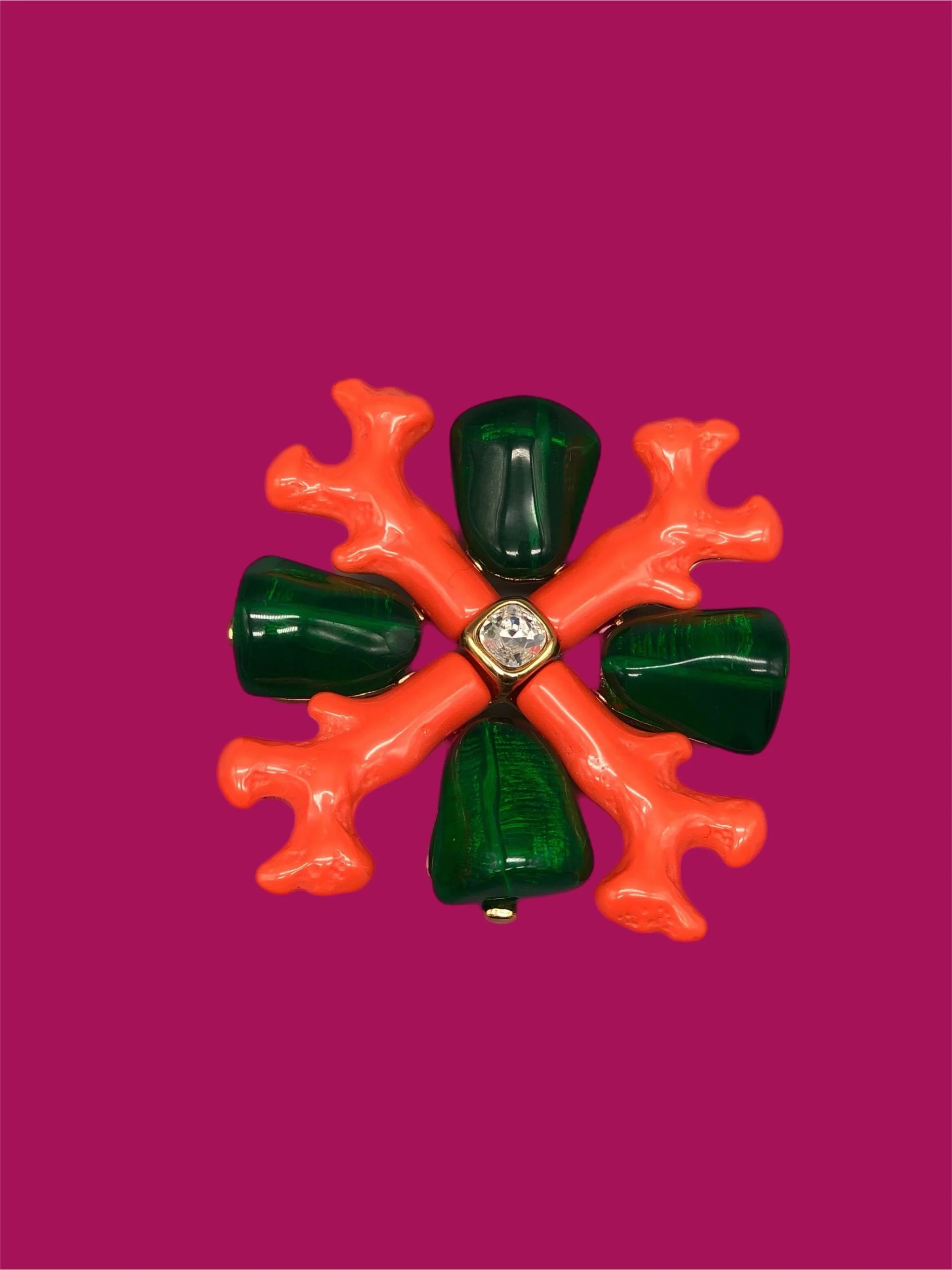 Kenneth Jay Lane coral-inspired brooch with orange branches and green cabochons, gold-tone, worn on white blazer — Crepundia Gioielli Bologna