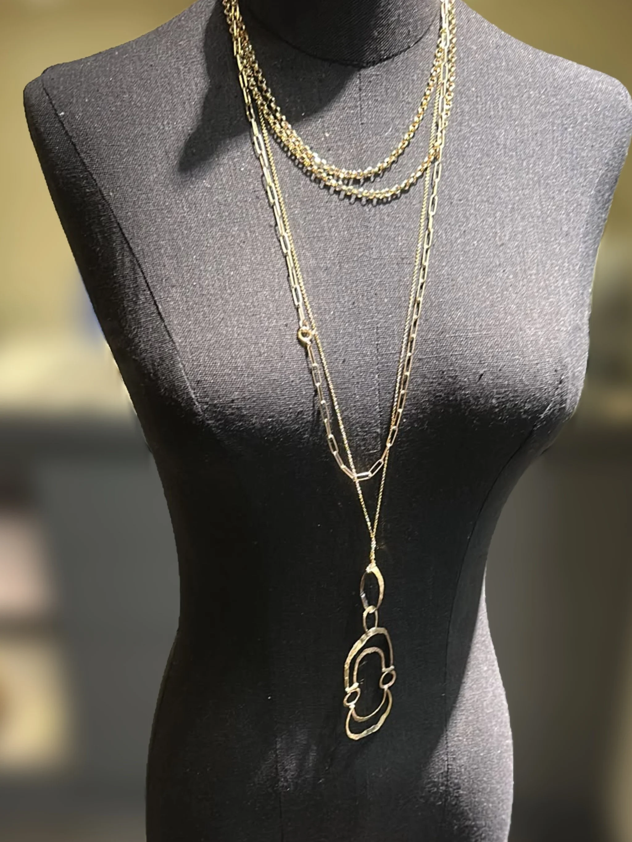 Ciondolo Contour di Claudia Cuzzeri in ottone opaco, con profili irregolari concentrici e forma aperta.