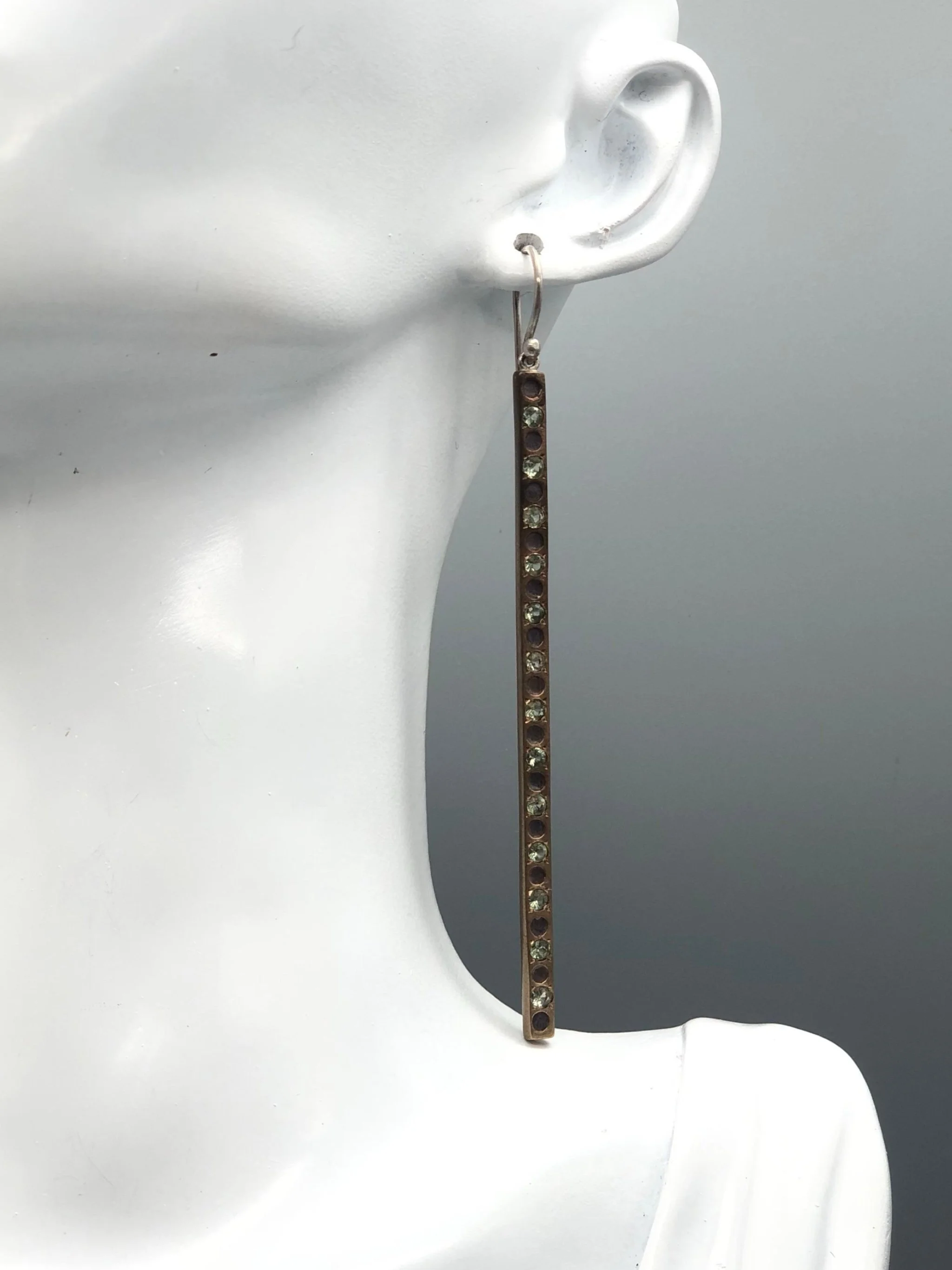 Raimondi long earrings in silver and bronze with green sapphires.