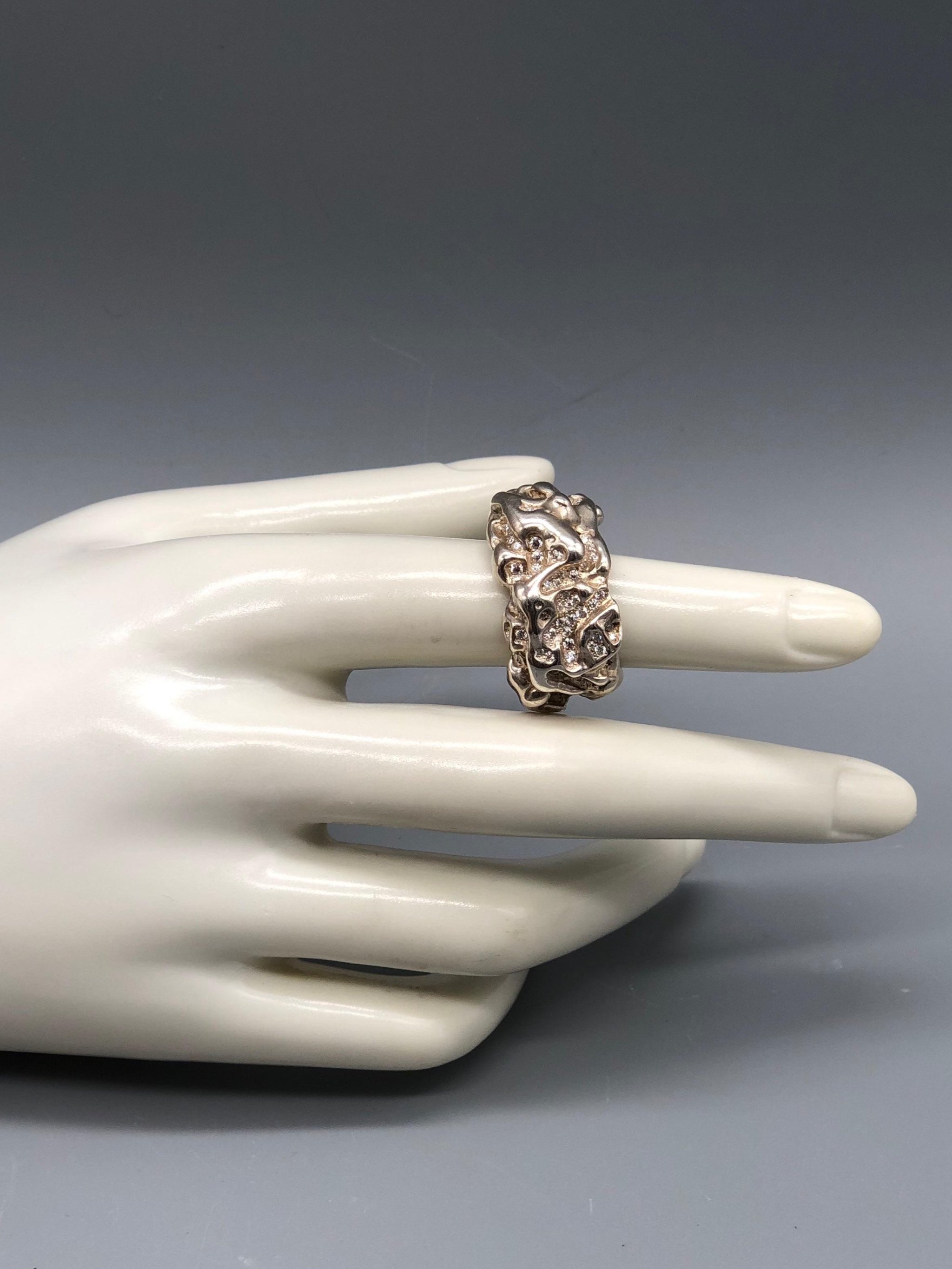 Portas Jewels Skinwalker ring set with 142 moissanites, featuring an intricate organic surface and sculptural silver band.