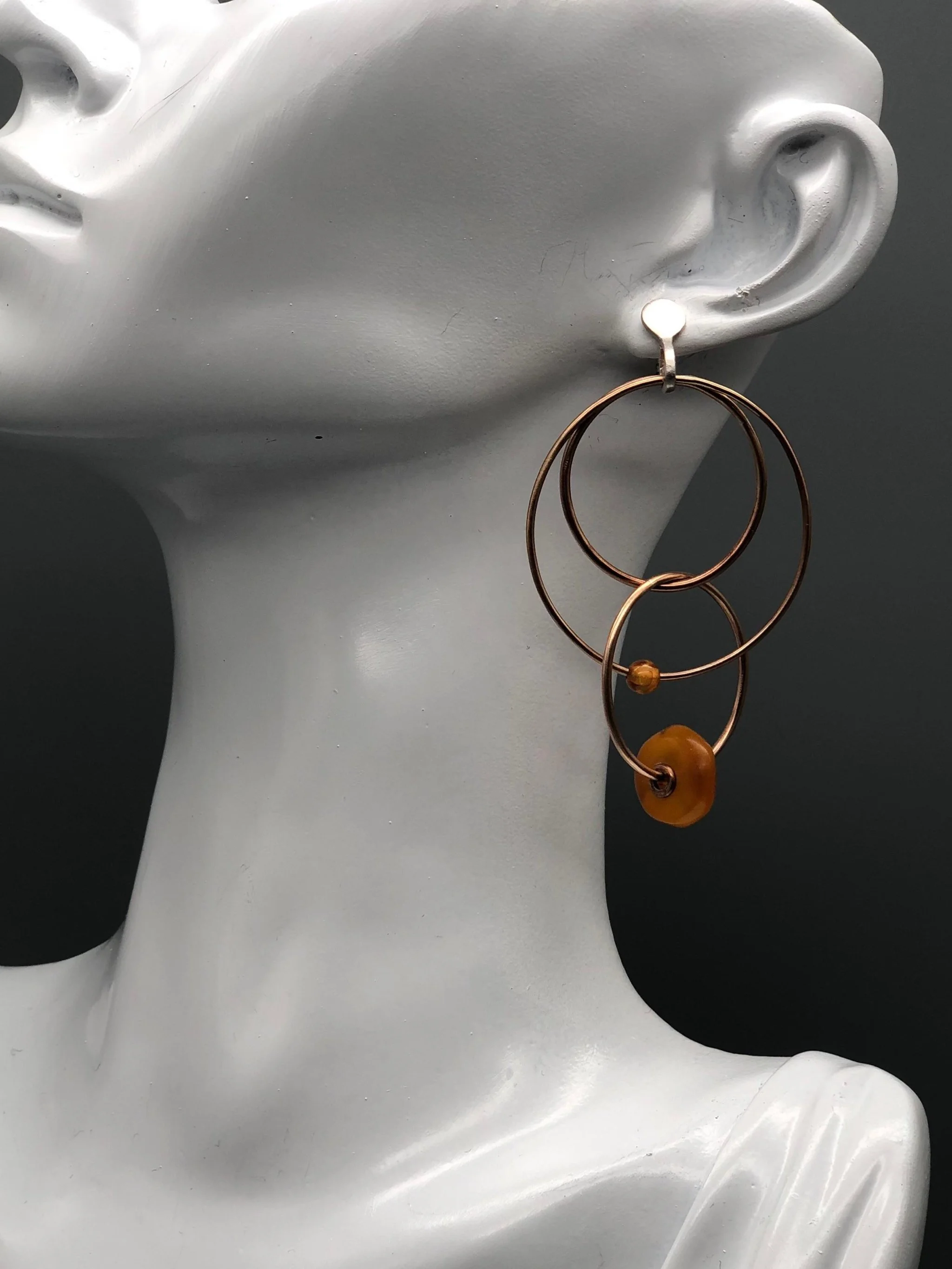 Padma Multicerchio bronze earrings with Morocco amber, Crepundia Gioielli Bologna.