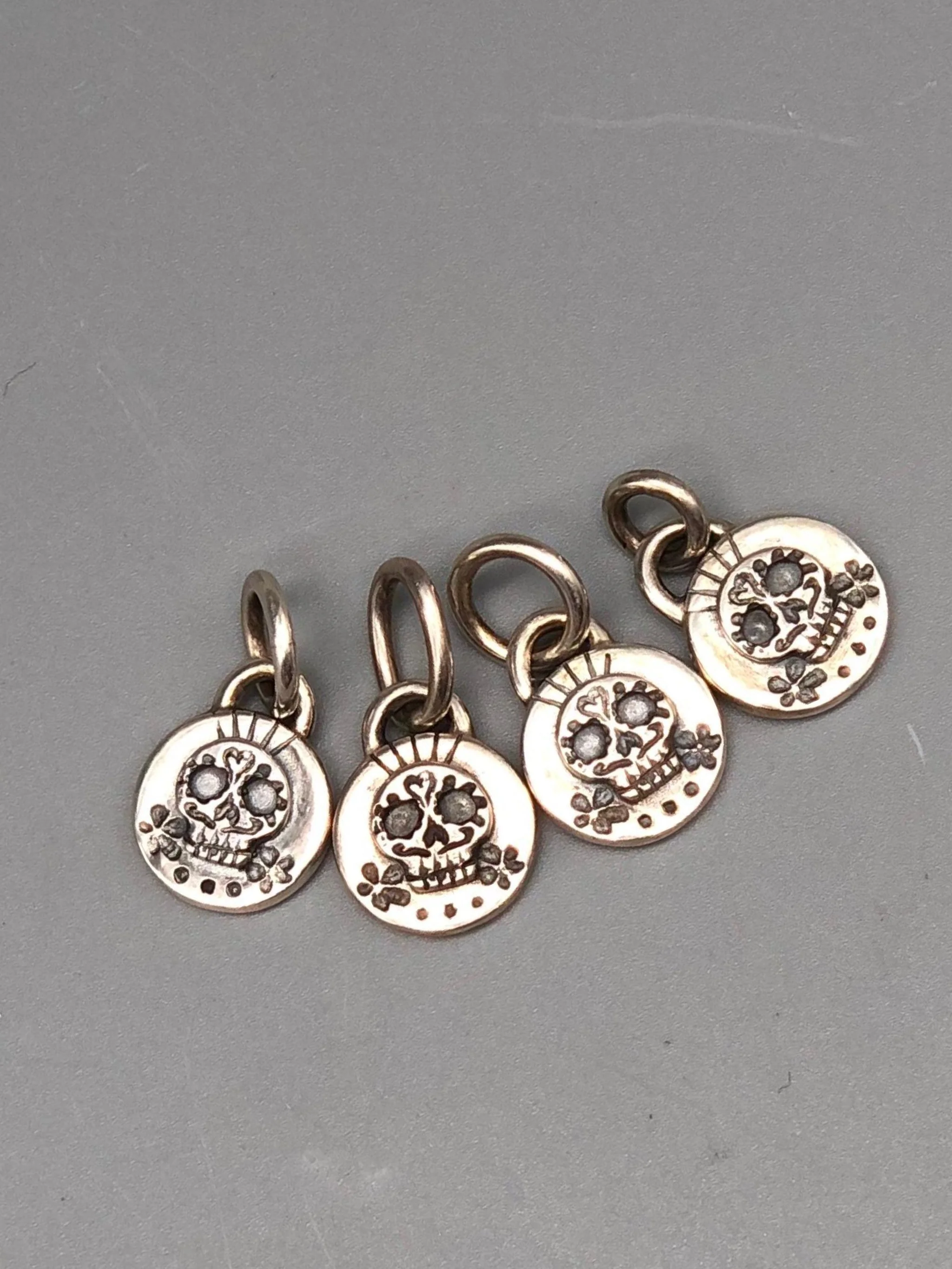 Sonja Markhoff Calavera pendants for Crepundia Gioielli Bologna in matte sterling silver, available with or without 18 kt gold detail