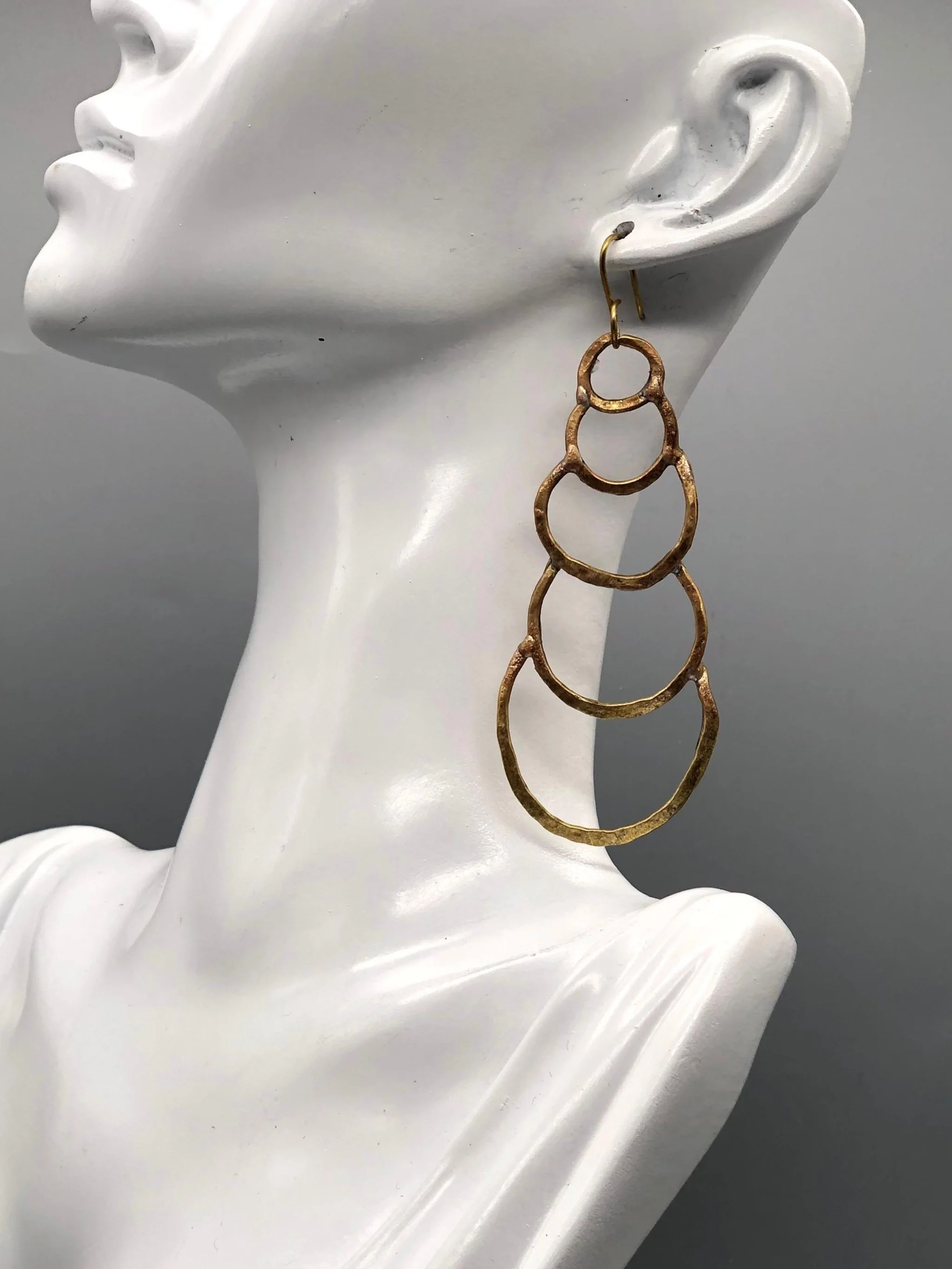 Orecchini Outline Drops di Claudia Cuzzeri in ottone opaco con forme circolari irregolari.
