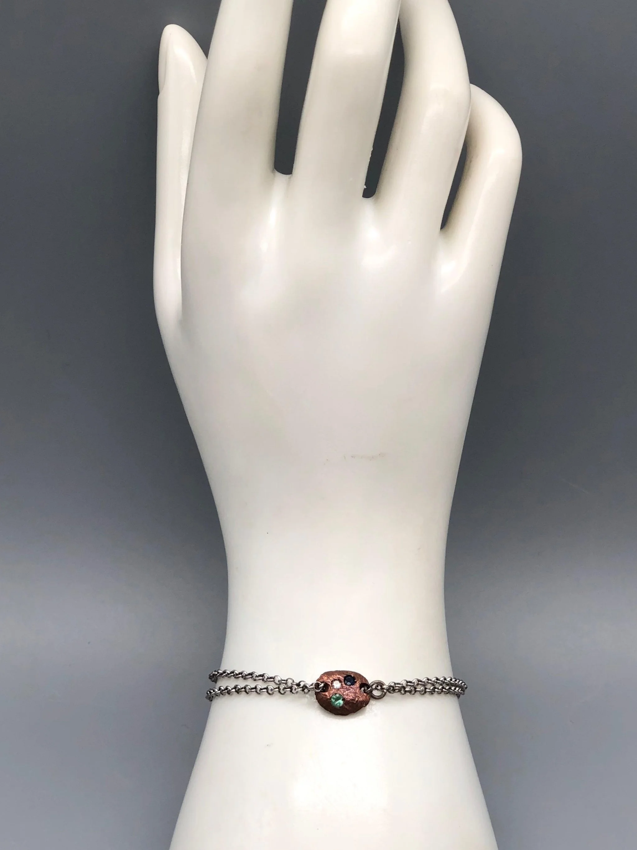 Crepundia Tracce bracelet in silver with irregular bronze element and coloured stones.