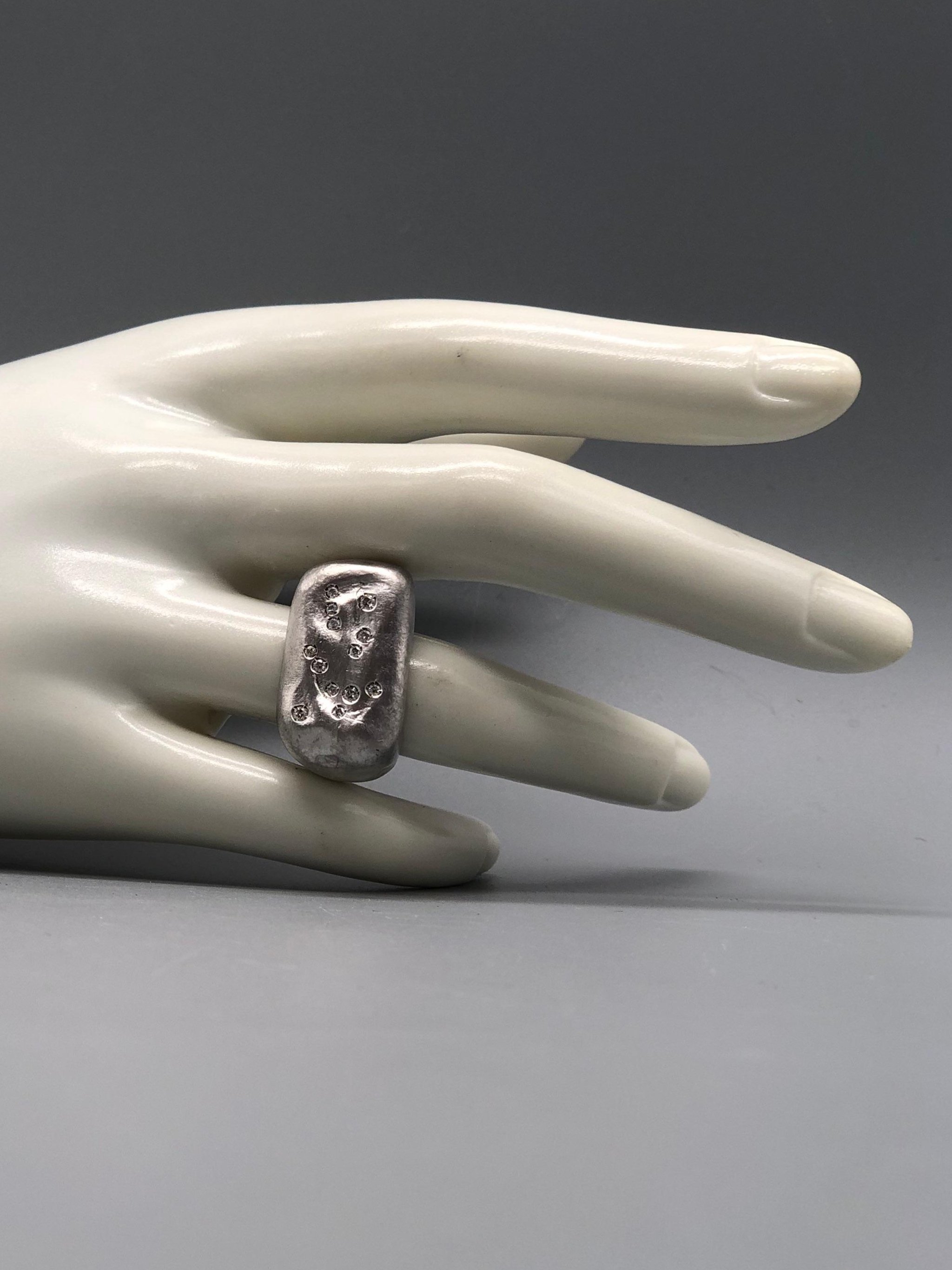 Crepundia Gioielli matte silver Echo ring with diamonds.