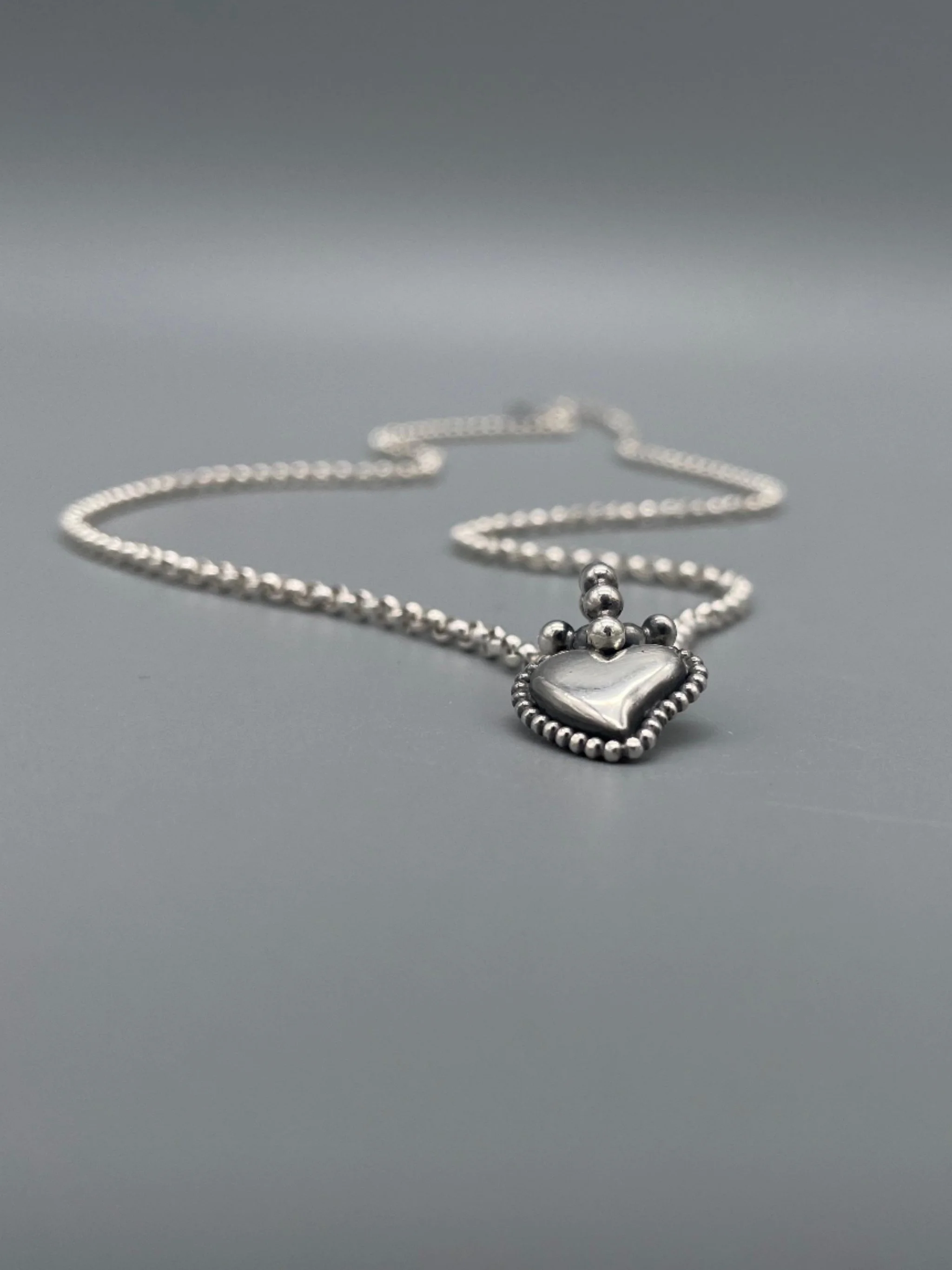 Sonja Markhoff Flaming Heart pendant in sterling silver, double-sided contemporary heart pendant by Crepundia Gioielli Bologna