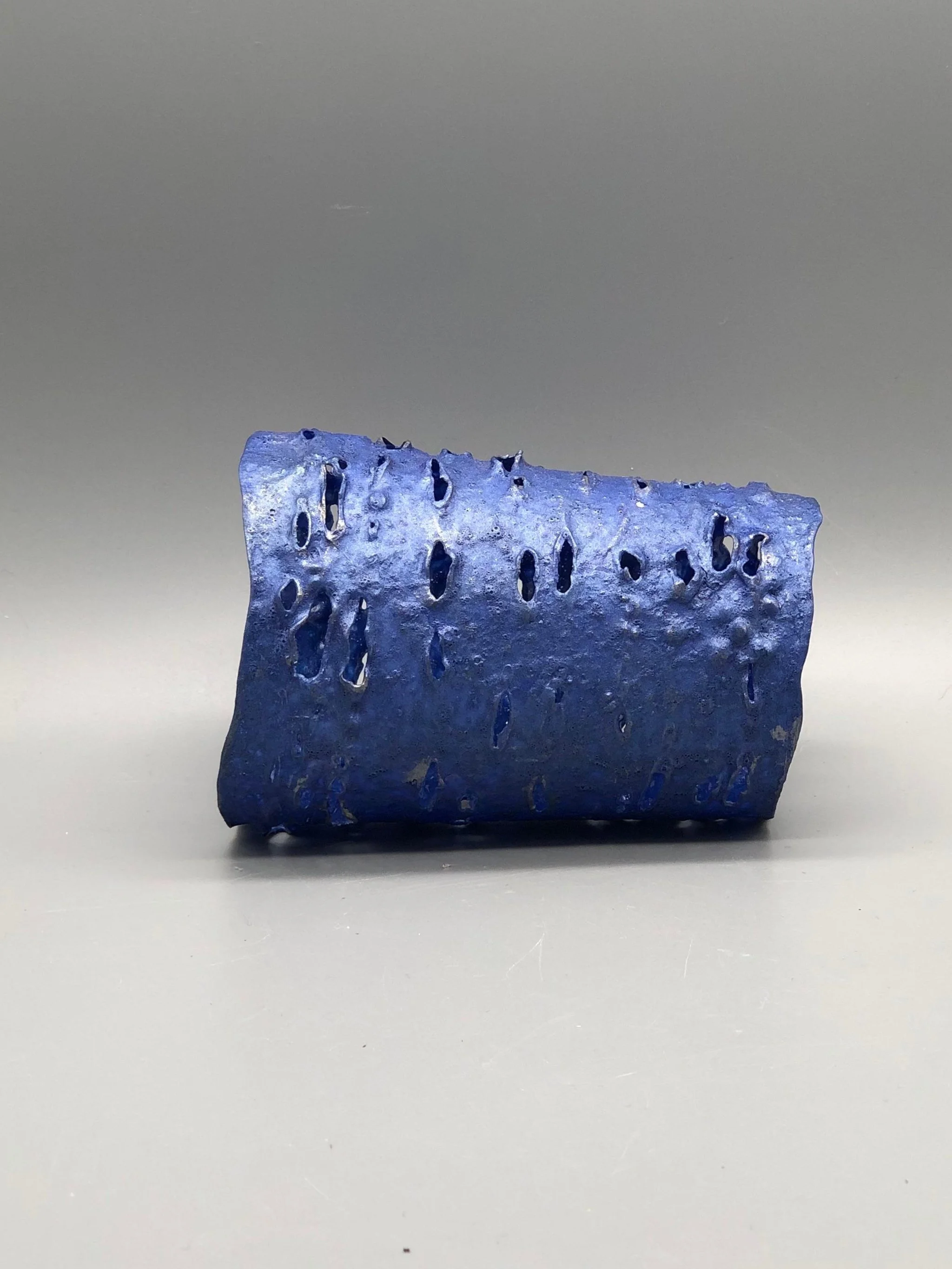 Trama Blue Metal bracelet by Giovanna Ussani, made from layered recycled plastic with perforated surface and metallic blue pigment.
