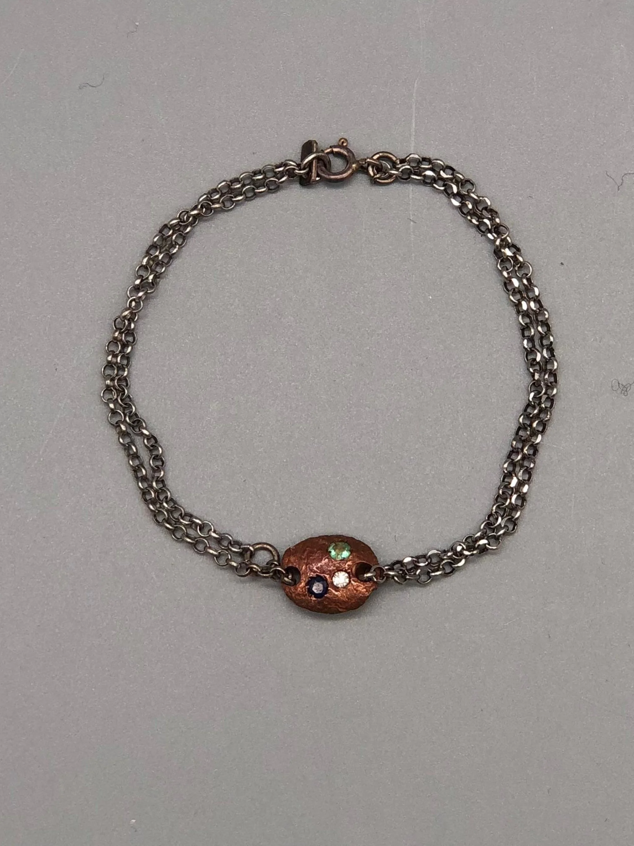 Crepundia Tracce bracelet in silver with irregular bronze element and coloured stones.