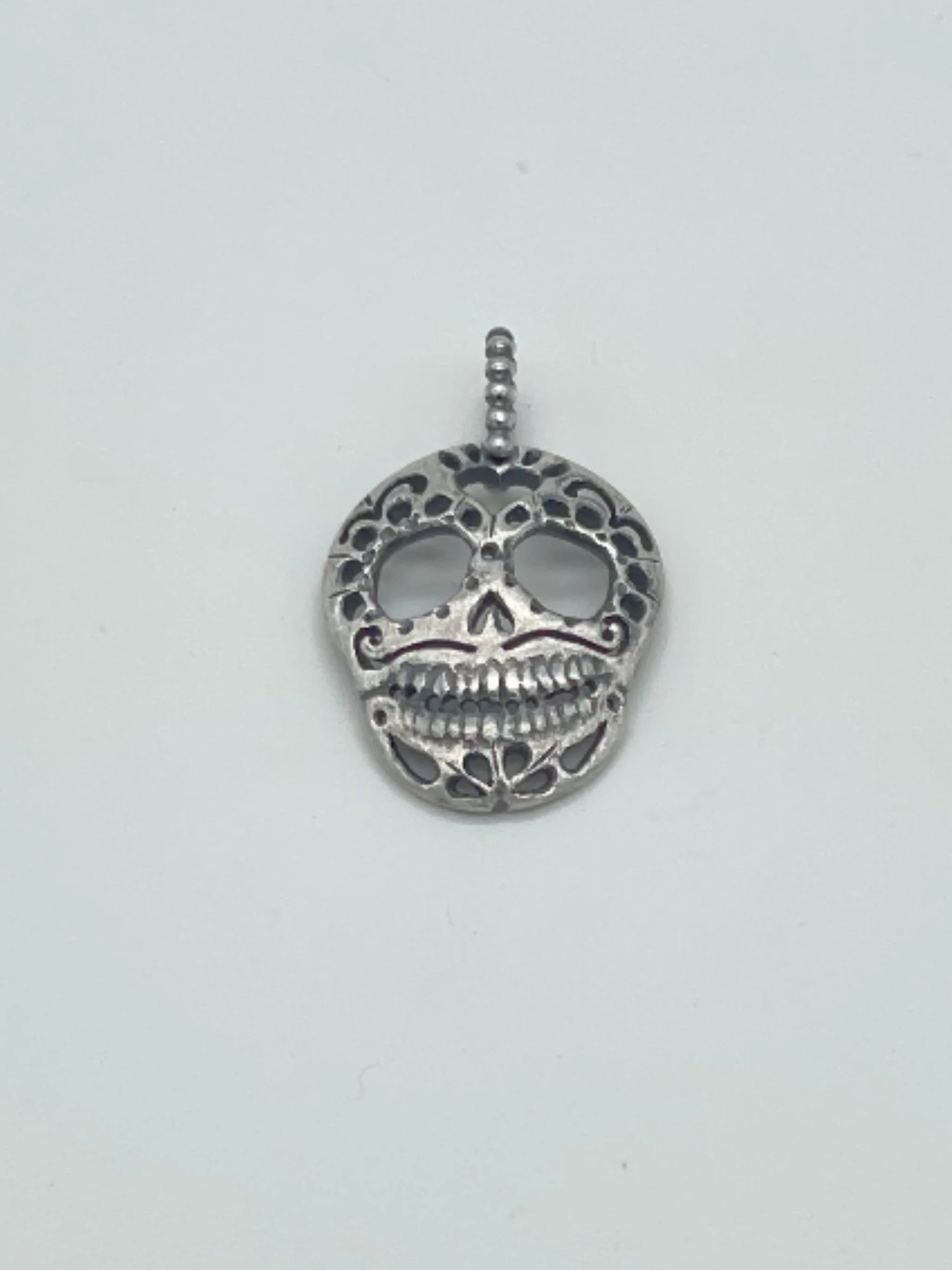 Sonja Markhoff Calavera de Dulce Cutout pendant in sterling silver with oxidized filed trace chain, contemporary skull necklace by Crepundia Gioielli Bologna