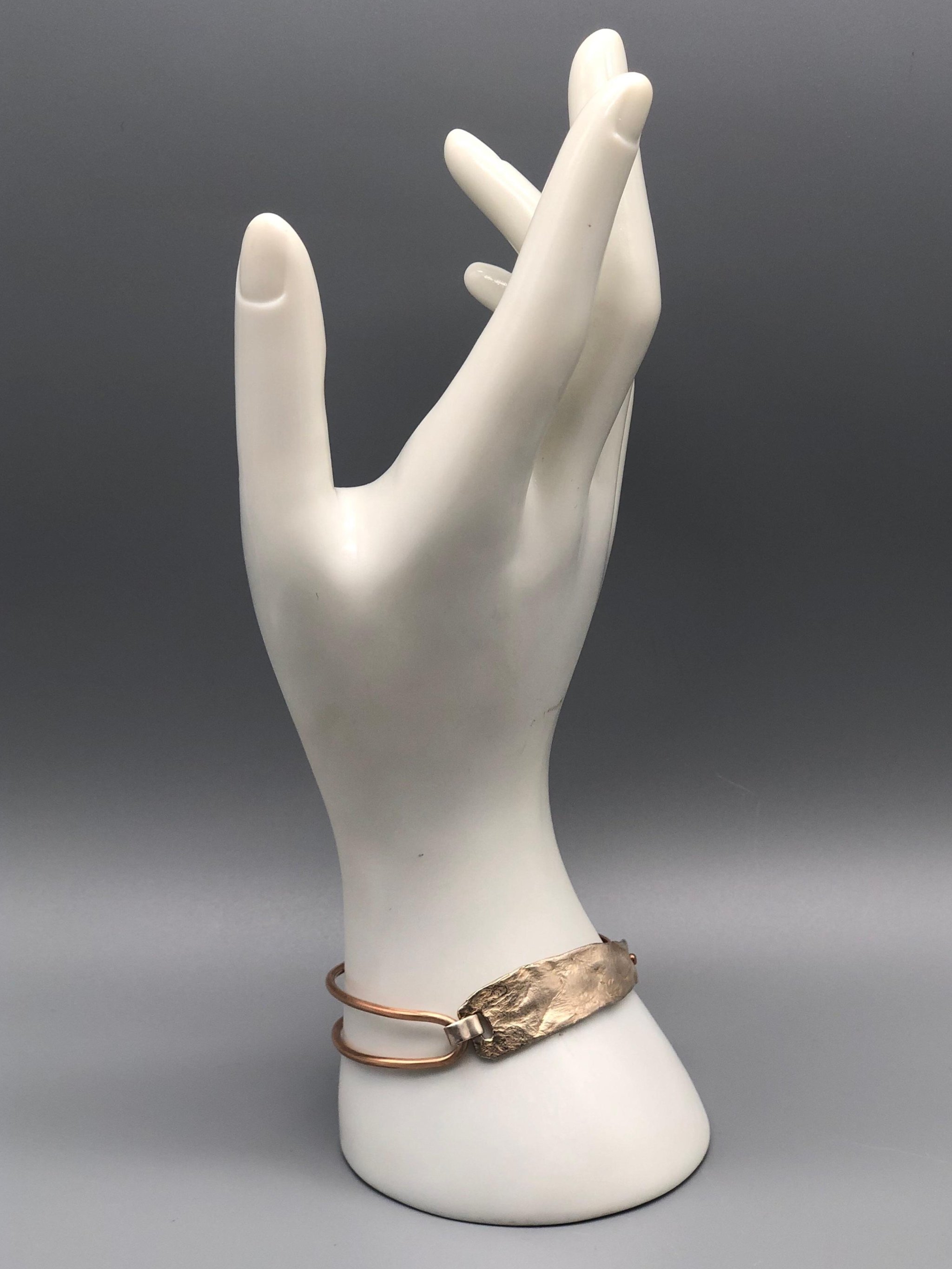 Padma Relief bracelet silver and bronze contemporary jewelry worn on wrist — Crepundia Gioielli — Crepundia Bologna