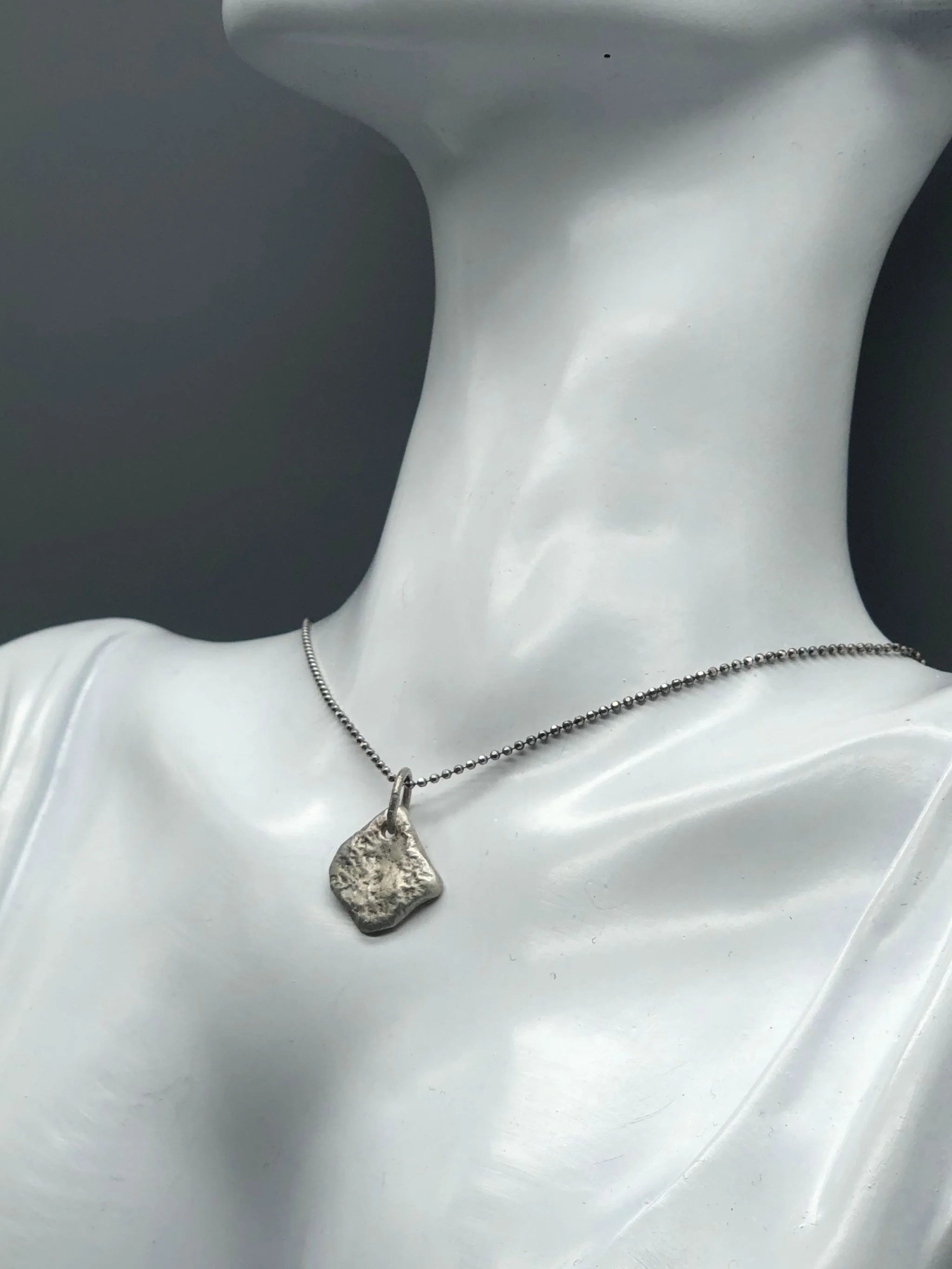 Fragment pendant Crepundia Gioielli Bologna, sterling silver hammered square charm, contemporary handmade jewelry