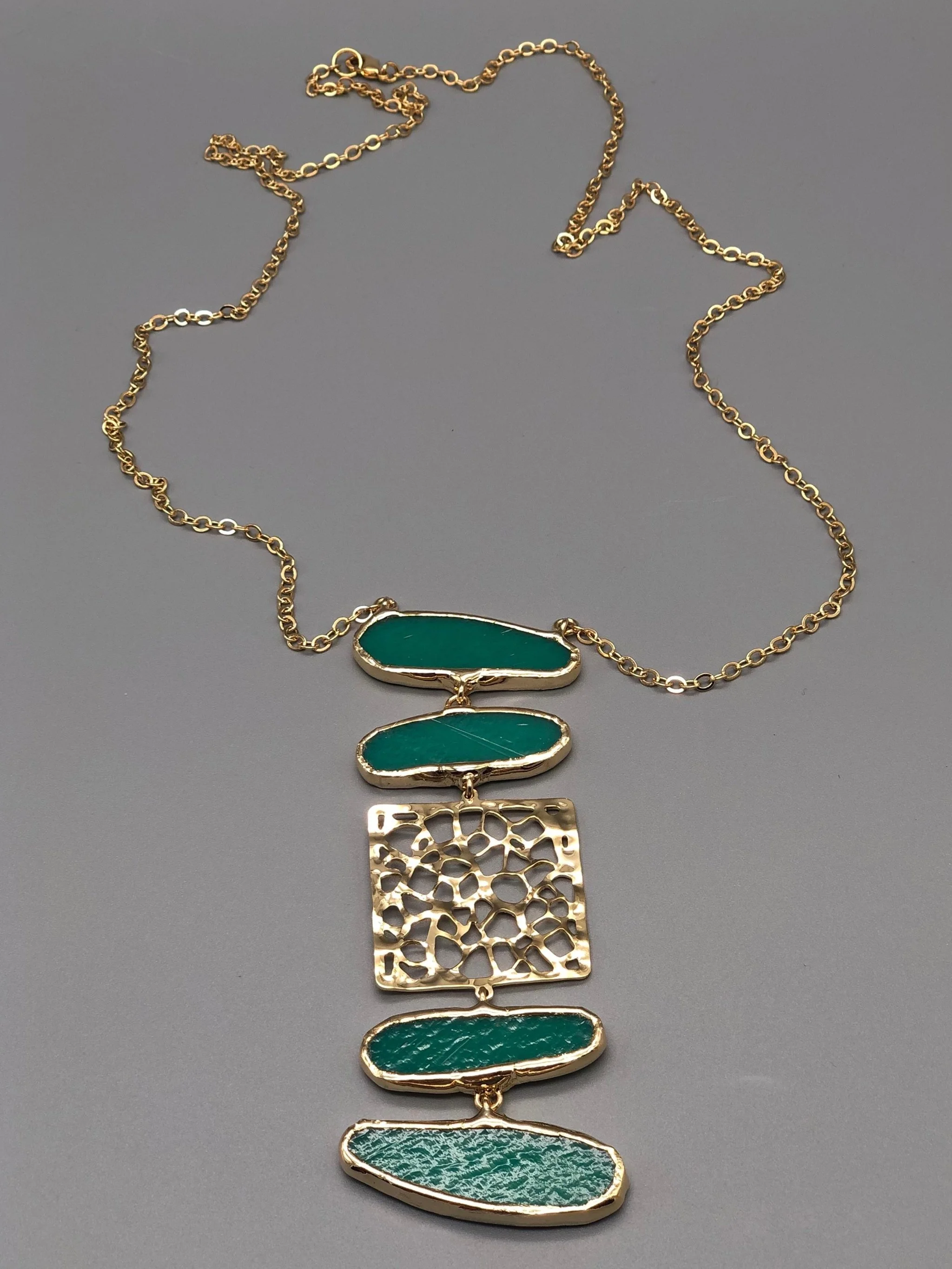 Anni Luce Organica Green necklace with green elements and a central openwork brass insert.