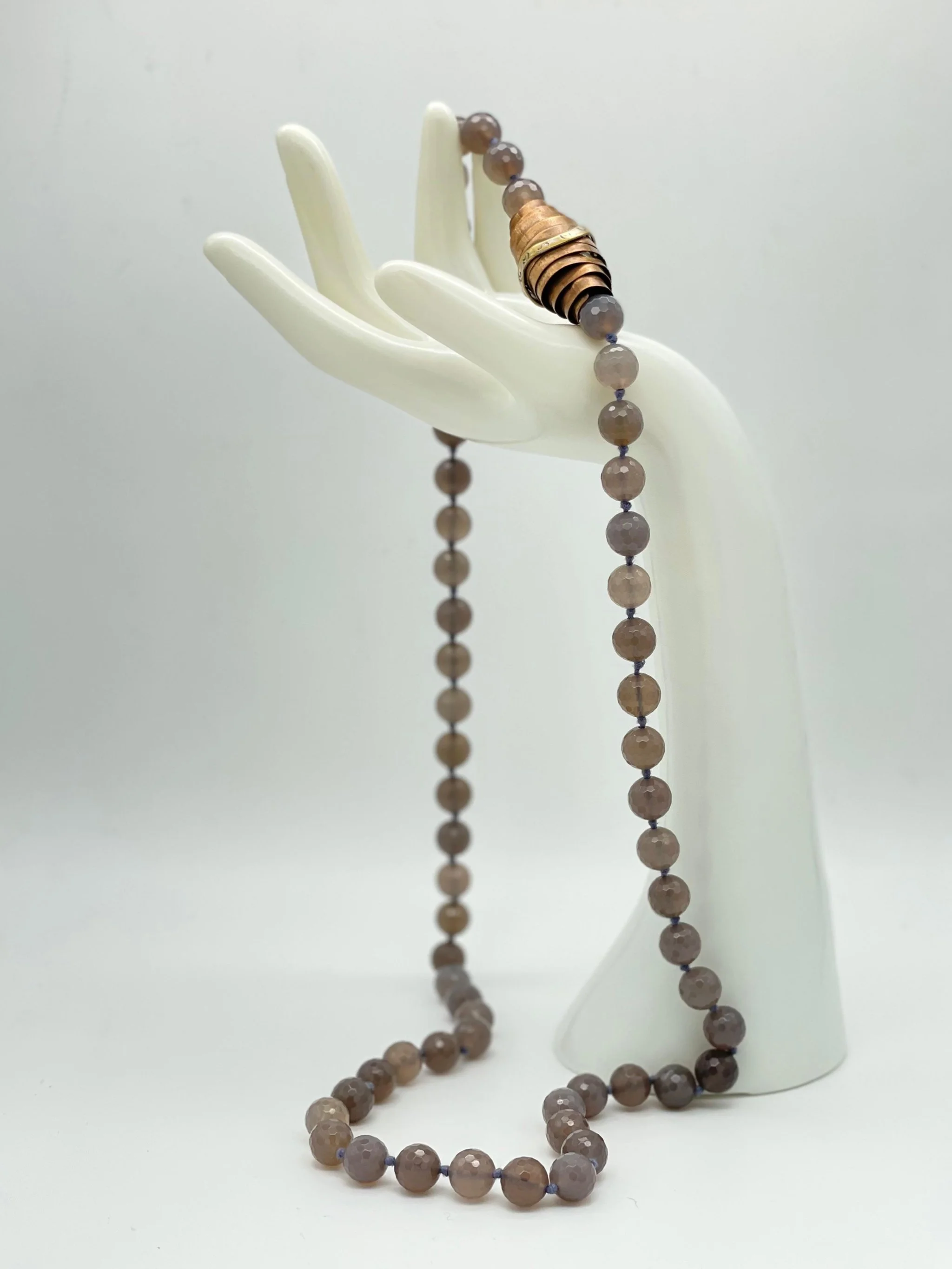 Faceted grey agate necklace with sculptural bronze and silver element by Padma — Crepundia Gioielli Bologna