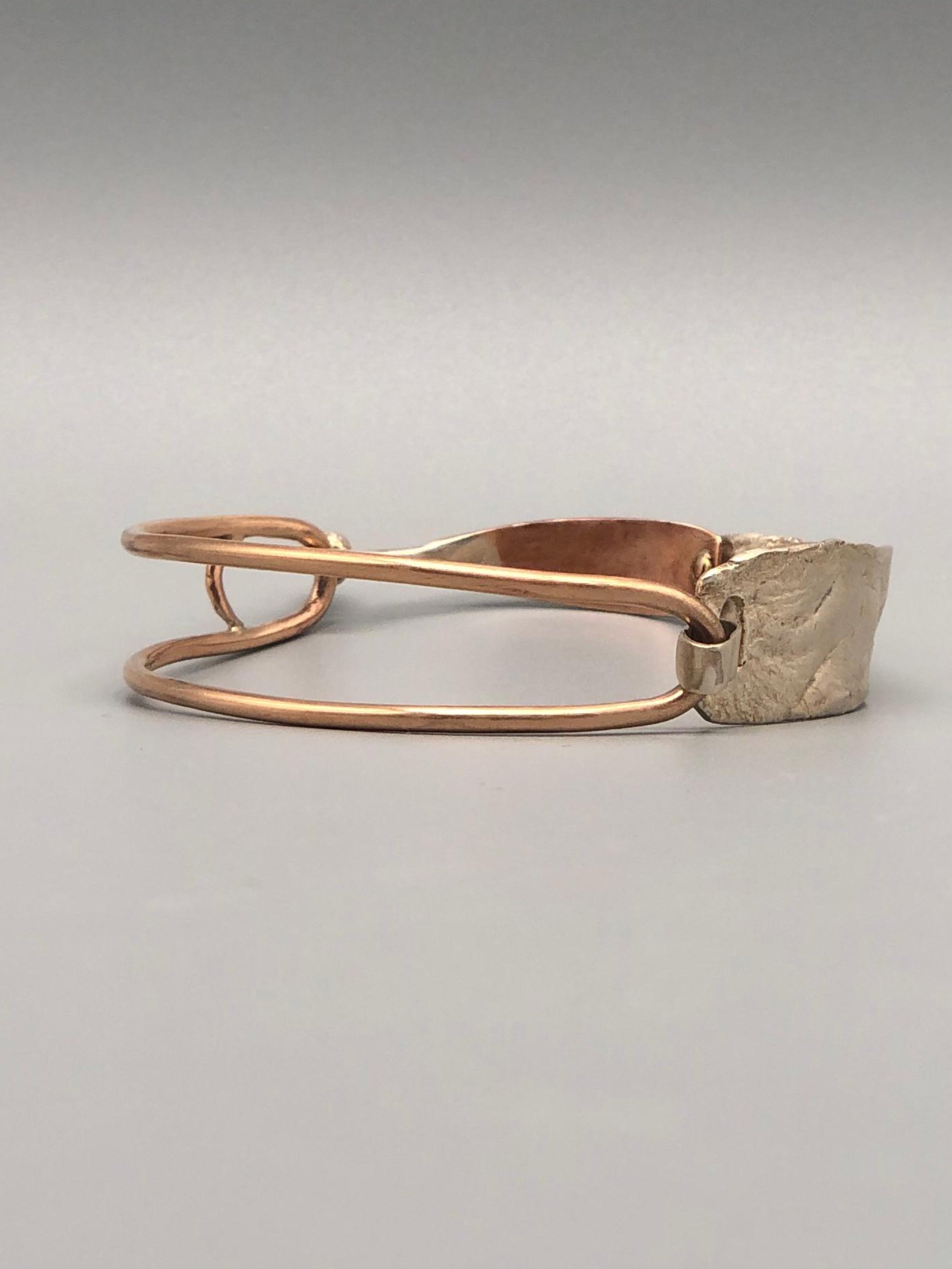Relief bracelet in silver and bronze by Padma with textured sculptural surface — Crepundia Gioielli — Crepundia Bologna contemporary jewelry