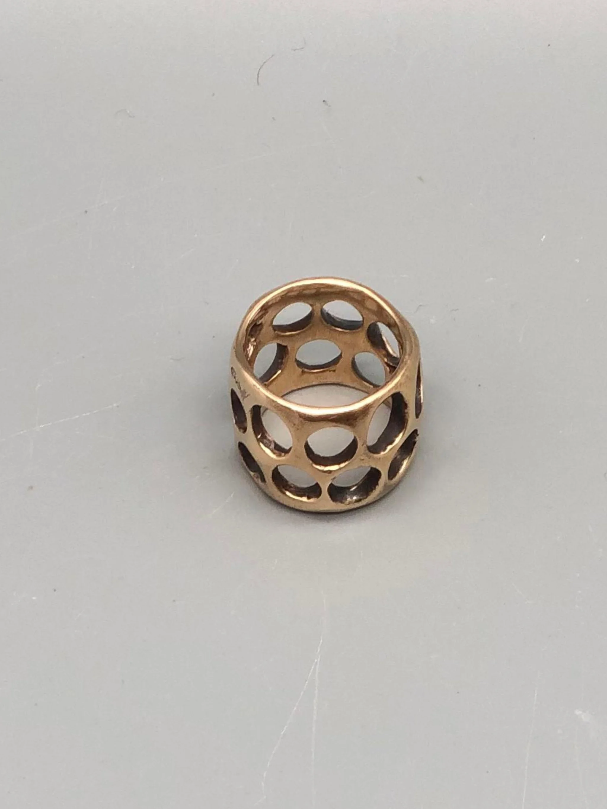 Padma Gruviera ring in rose bronze with sculptural openwork structure. Contemporary handmade statement ring photographed at Crepundia Gioielli Bologna.
