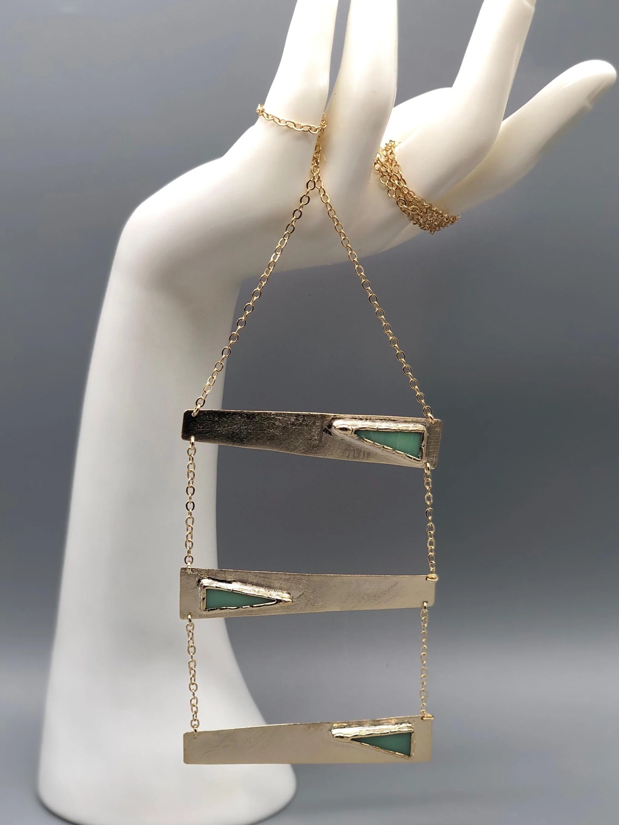 Contemporary rectangular necklace by Anni Luce in gold-plated metal with mint green enamel detail, Crepundia Gioielli Bologna