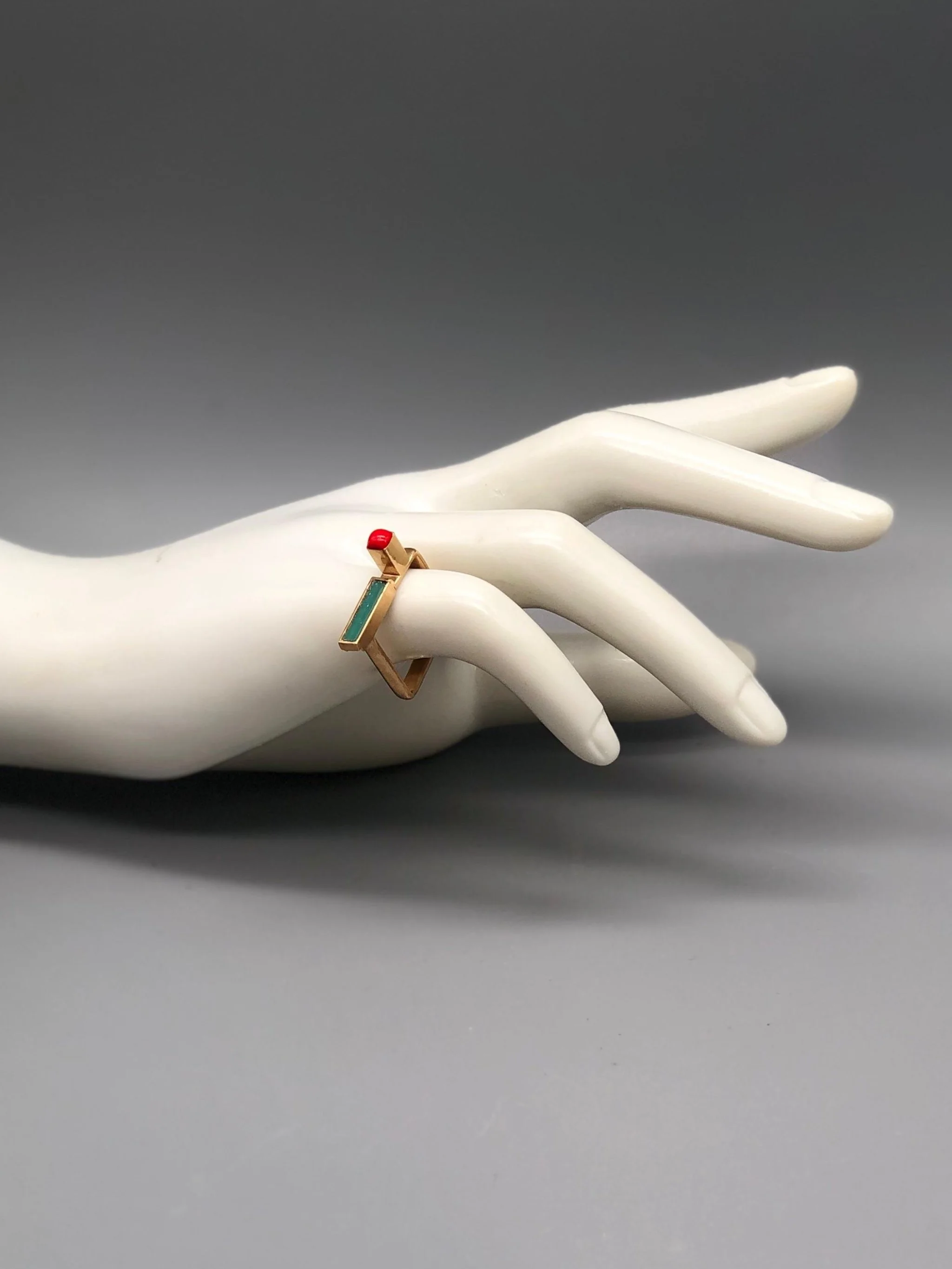 Contemporary rings by EL Gioielli for Crepundia Gioielli Bologna, geometric gold-toned rings with colored enamel details displayed on neutral background and worn on hand