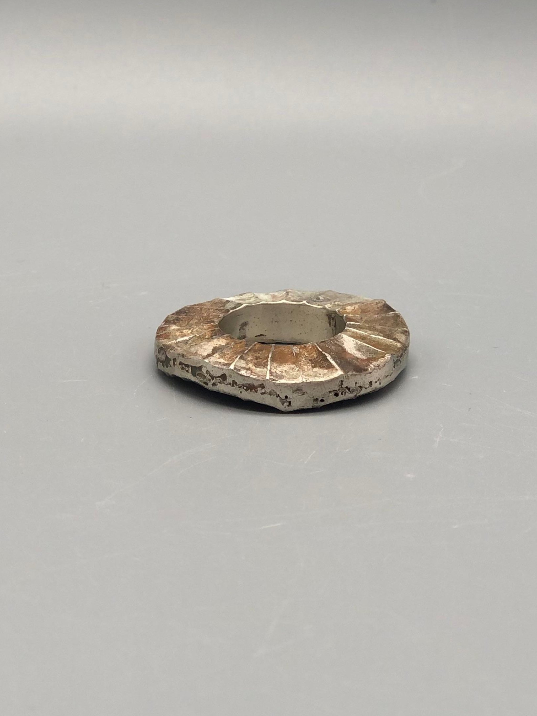 Mangàni Sole ring in oxidized 925 sterling silver with irregular circular form and radial textured surface.