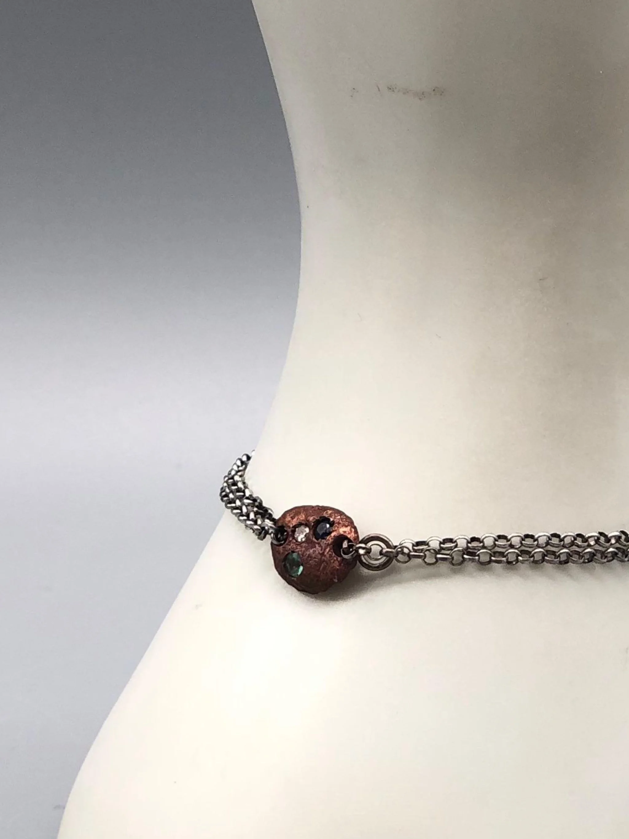 Crepundia Tracce bracelet in silver with irregular bronze element and coloured stones.