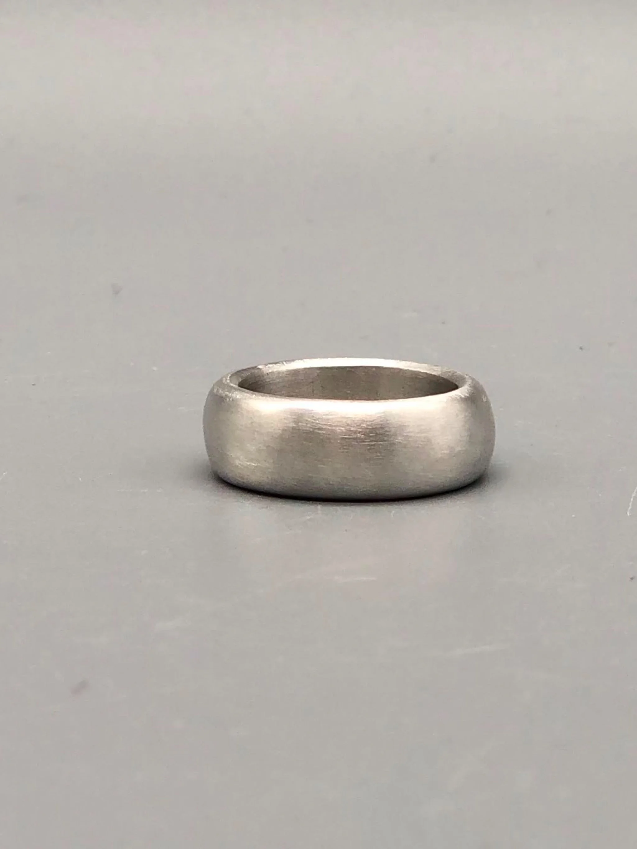 Anello Esse in argento opaco, gioiello contemporaneo dal profilo morbido e dalla fascia ampia. Esse ring in matte silver, contemporary jewellery with a soft profile and a wide band.