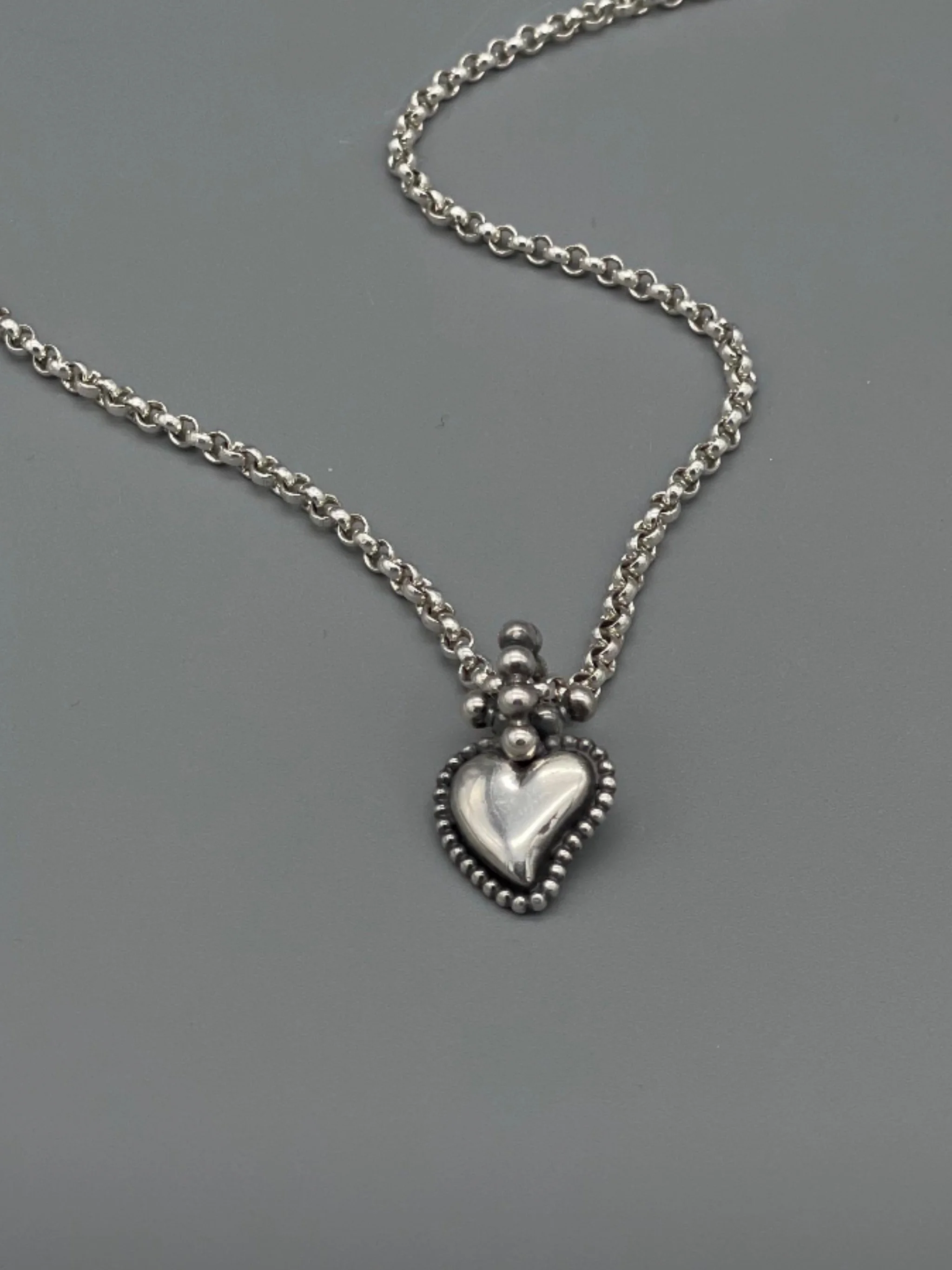 Sonja Markhoff Flaming Heart pendant in sterling silver, double-sided contemporary heart pendant by Crepundia Gioielli Bologna