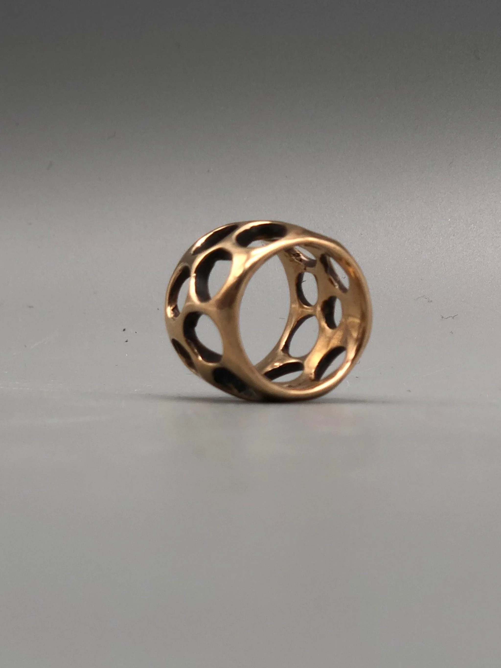 Padma Gruviera ring in rose bronze with sculptural openwork structure. Contemporary handmade statement ring photographed at Crepundia Gioielli Bologna.