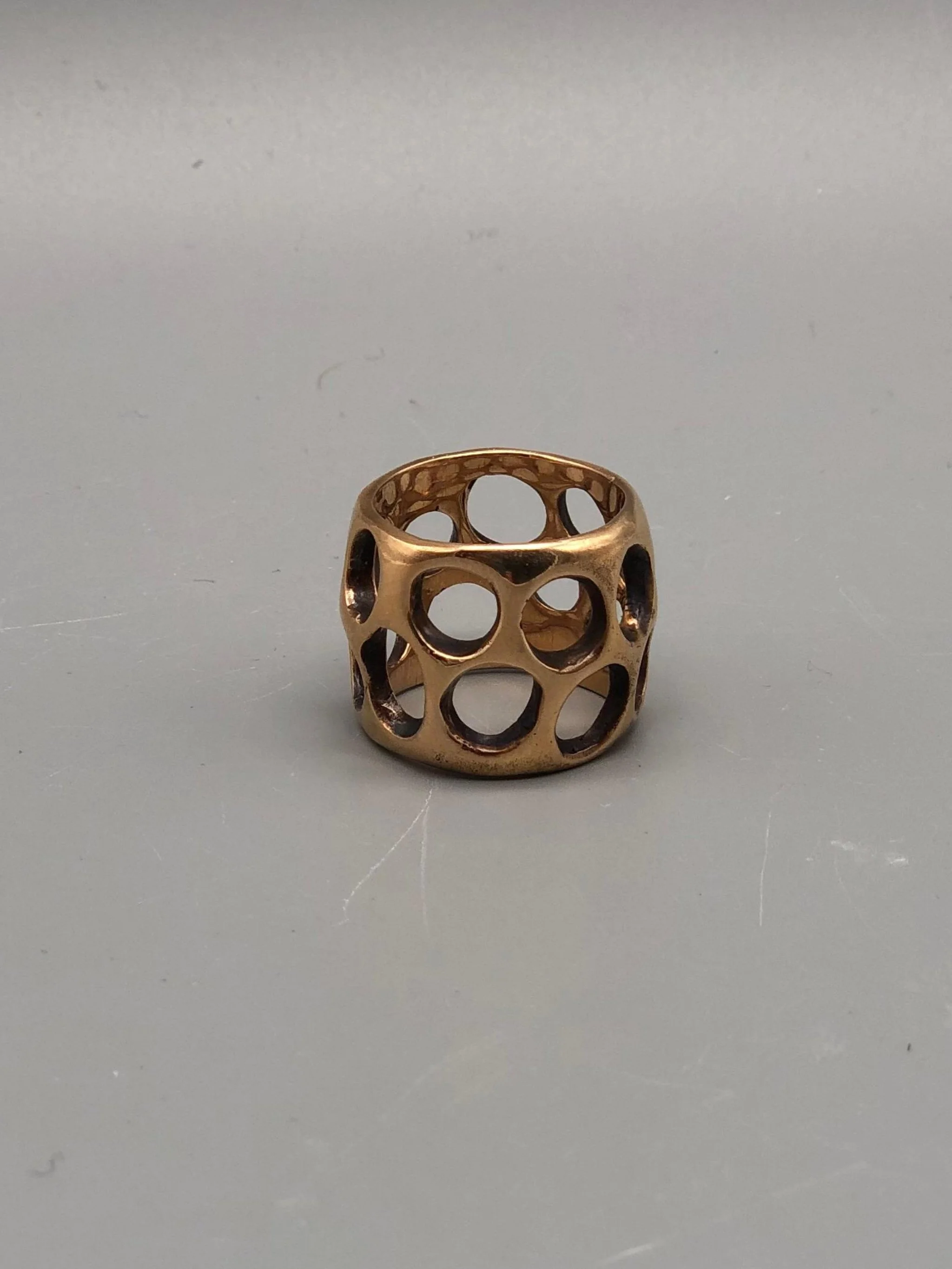 Padma Gruviera ring in rose bronze with sculptural openwork structure. Contemporary handmade statement ring photographed at Crepundia Gioielli Bologna.