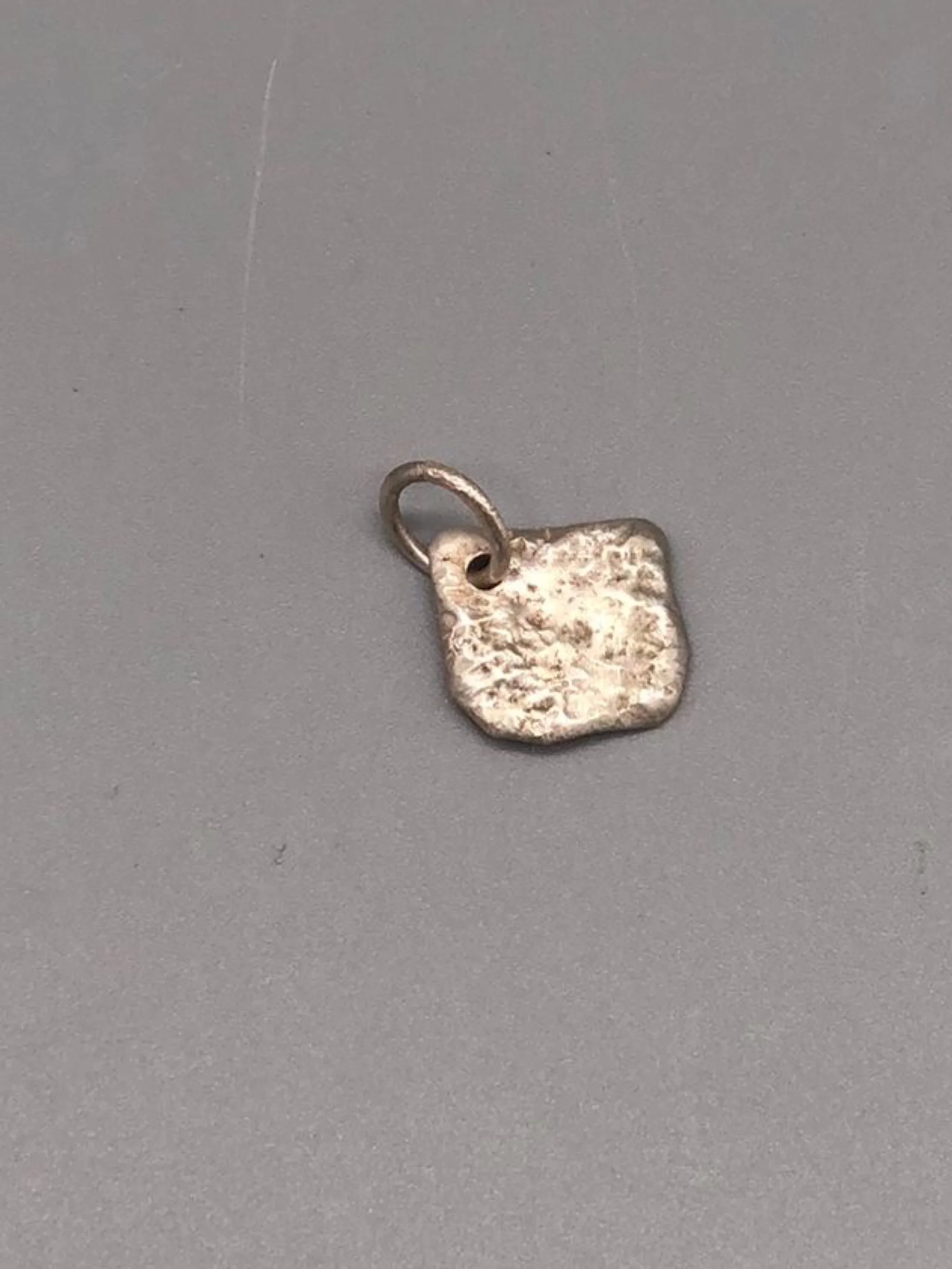 Bazaart_ Fragment pendant Crepundia Gioielli Bologna, sterling silver hammered square charm, contemporary handmade jewelry