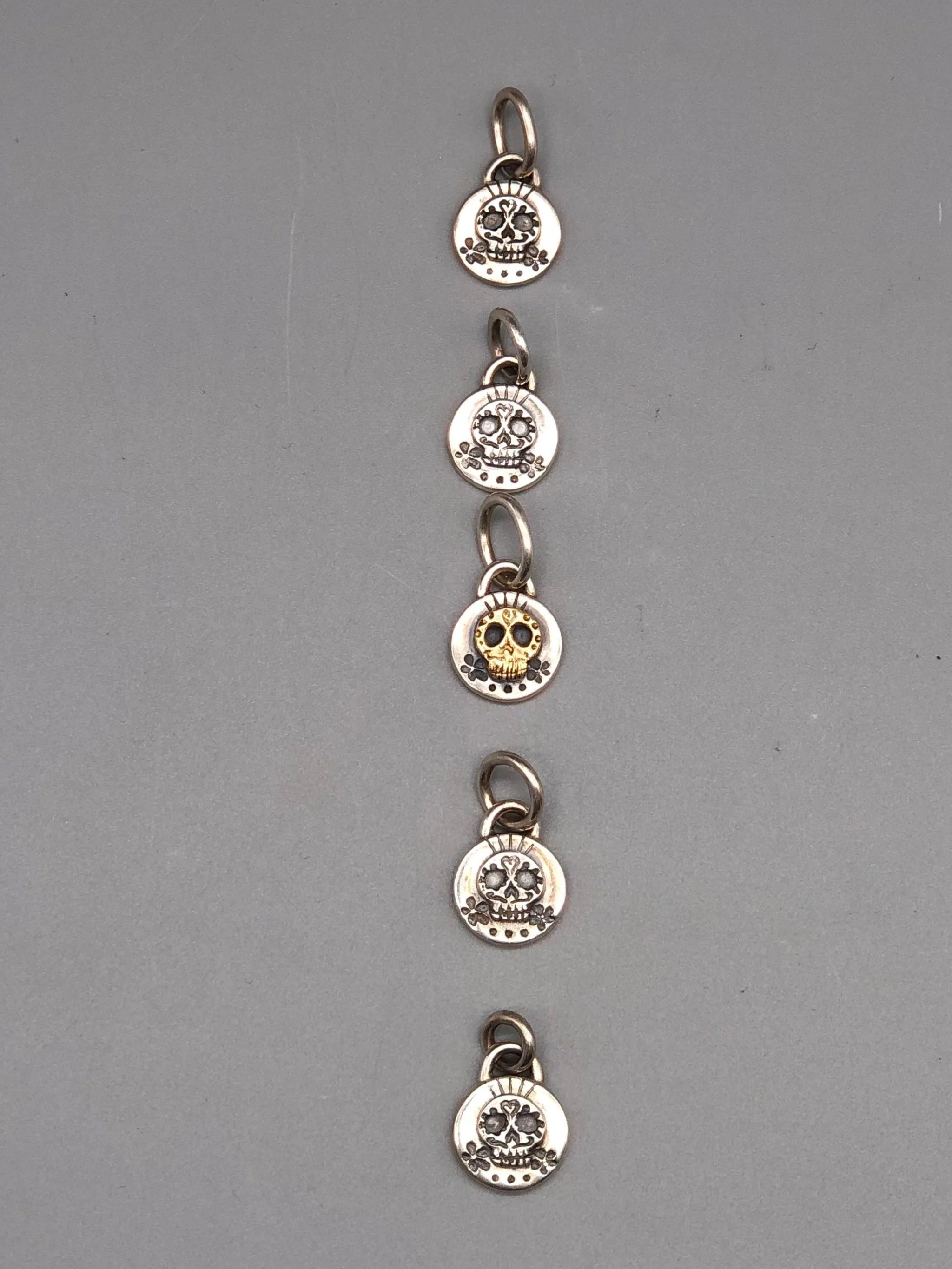 Sonja Markhoff Calavera pendants for Crepundia Gioielli Bologna in matte sterling silver, available with or without 18 kt gold detail