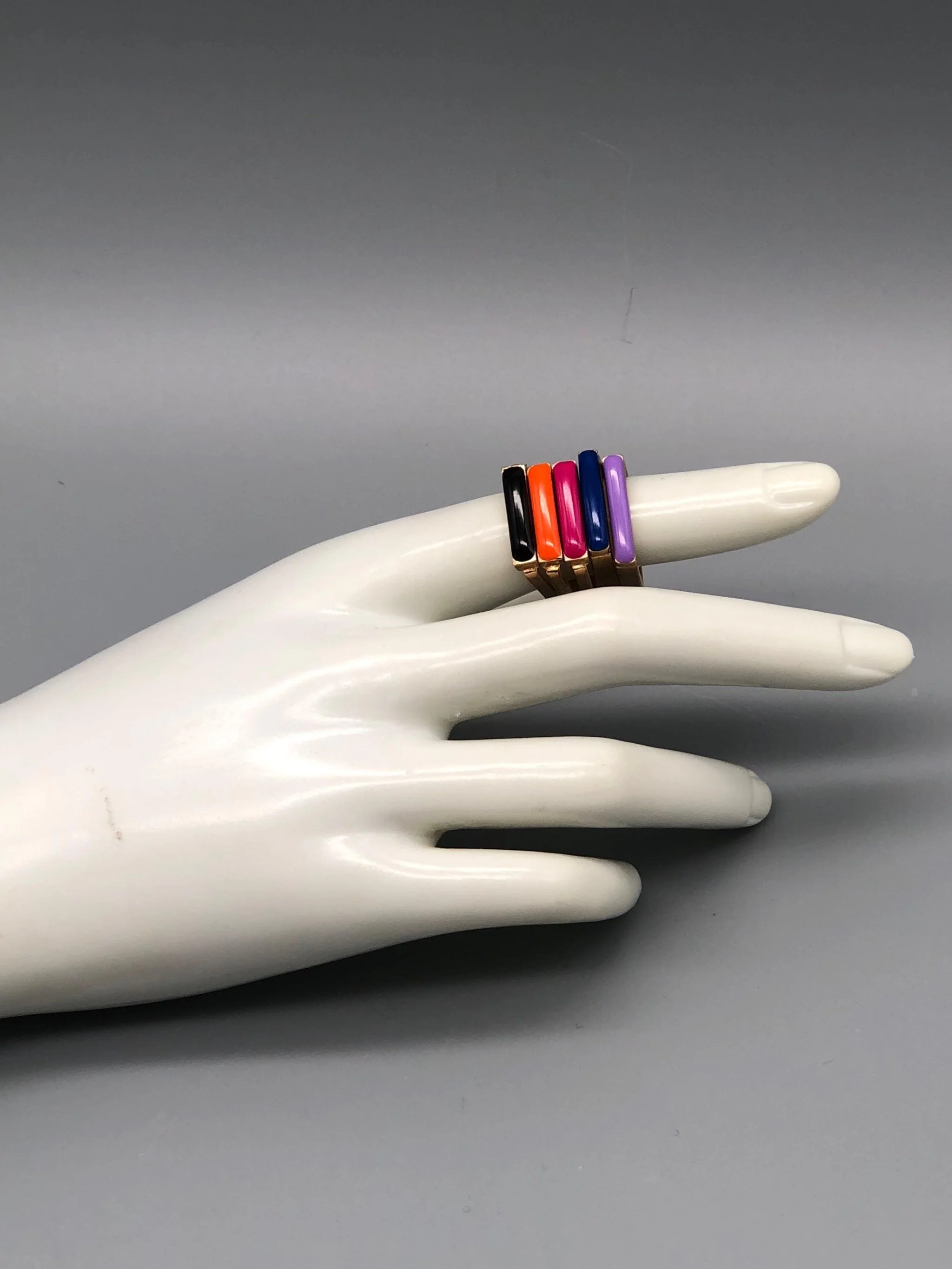 Slim enamel rings in bronze with gold finish, available in black, orange, pink, cornflower blue and purple enamel, Crepundia Gioielli Bologna.