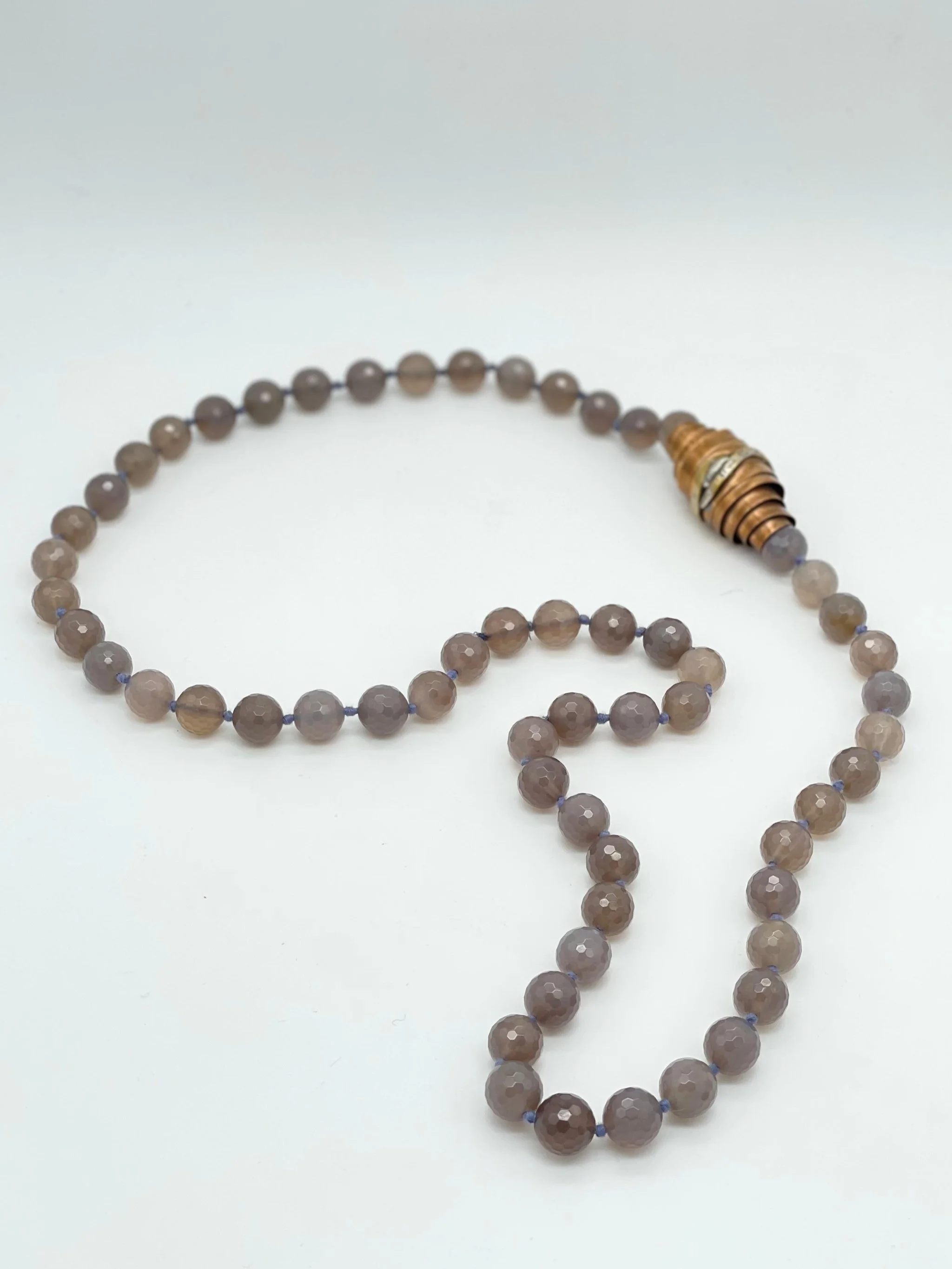 Faceted grey agate necklace with sculptural bronze and silver element by Padma — Crepundia Gioielli Bologna