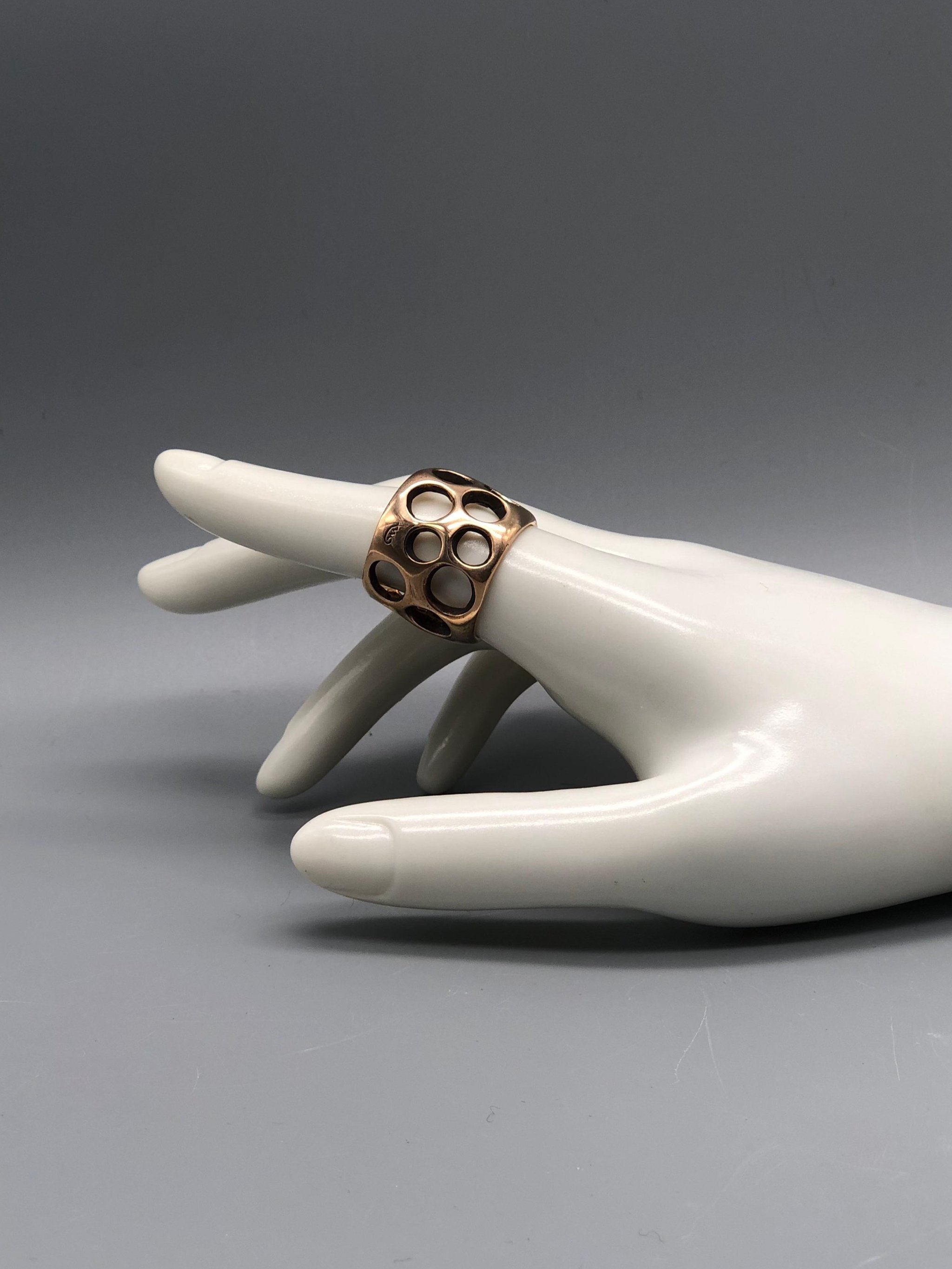 Padma Gruviera ring in rose bronze with sculptural openwork structure. Contemporary handmade statement ring photographed at Crepundia Gioielli Bologna.