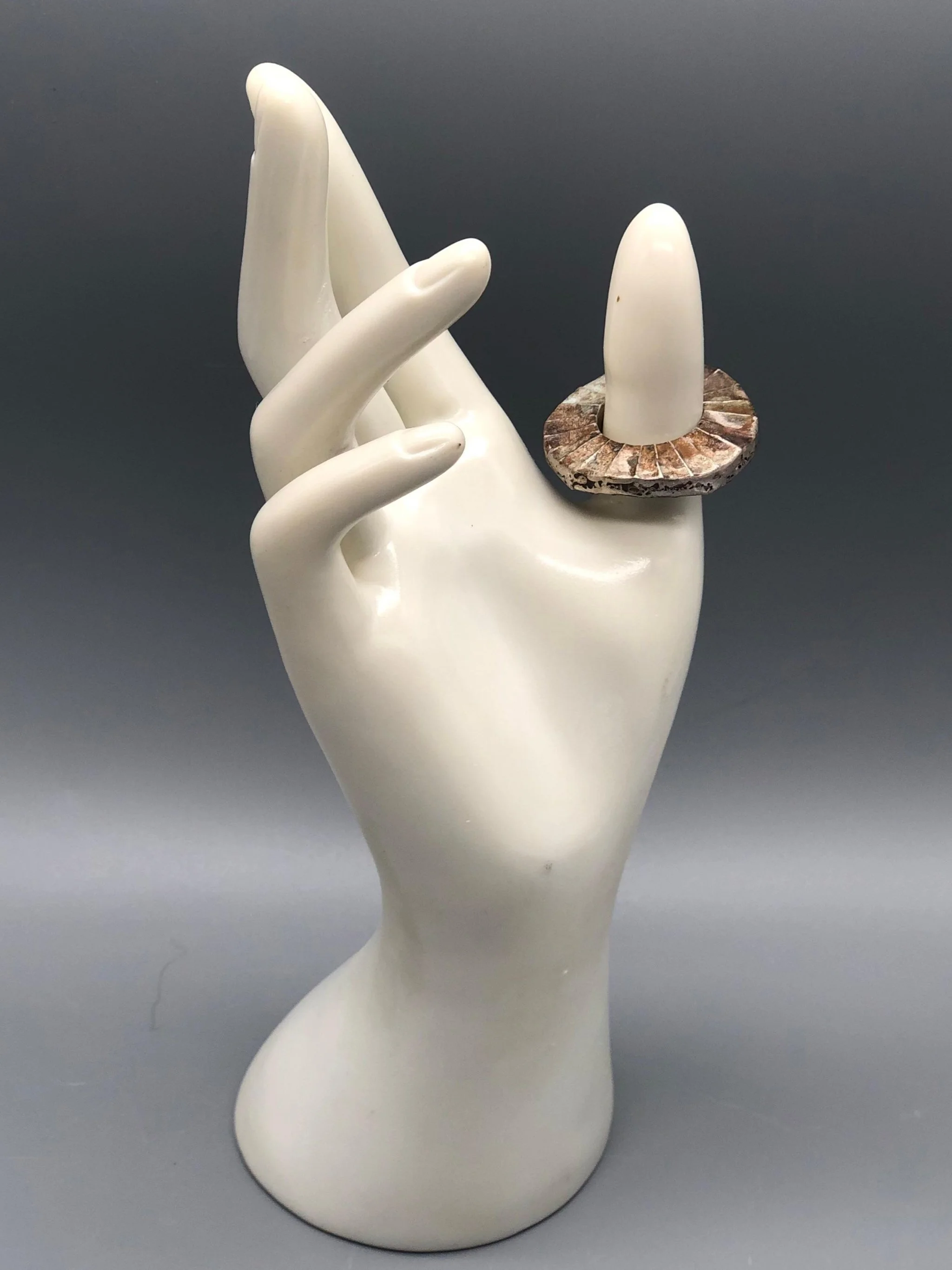 Mangàni Sole ring in oxidized 925 sterling silver with irregular circular form and radial textured surface.