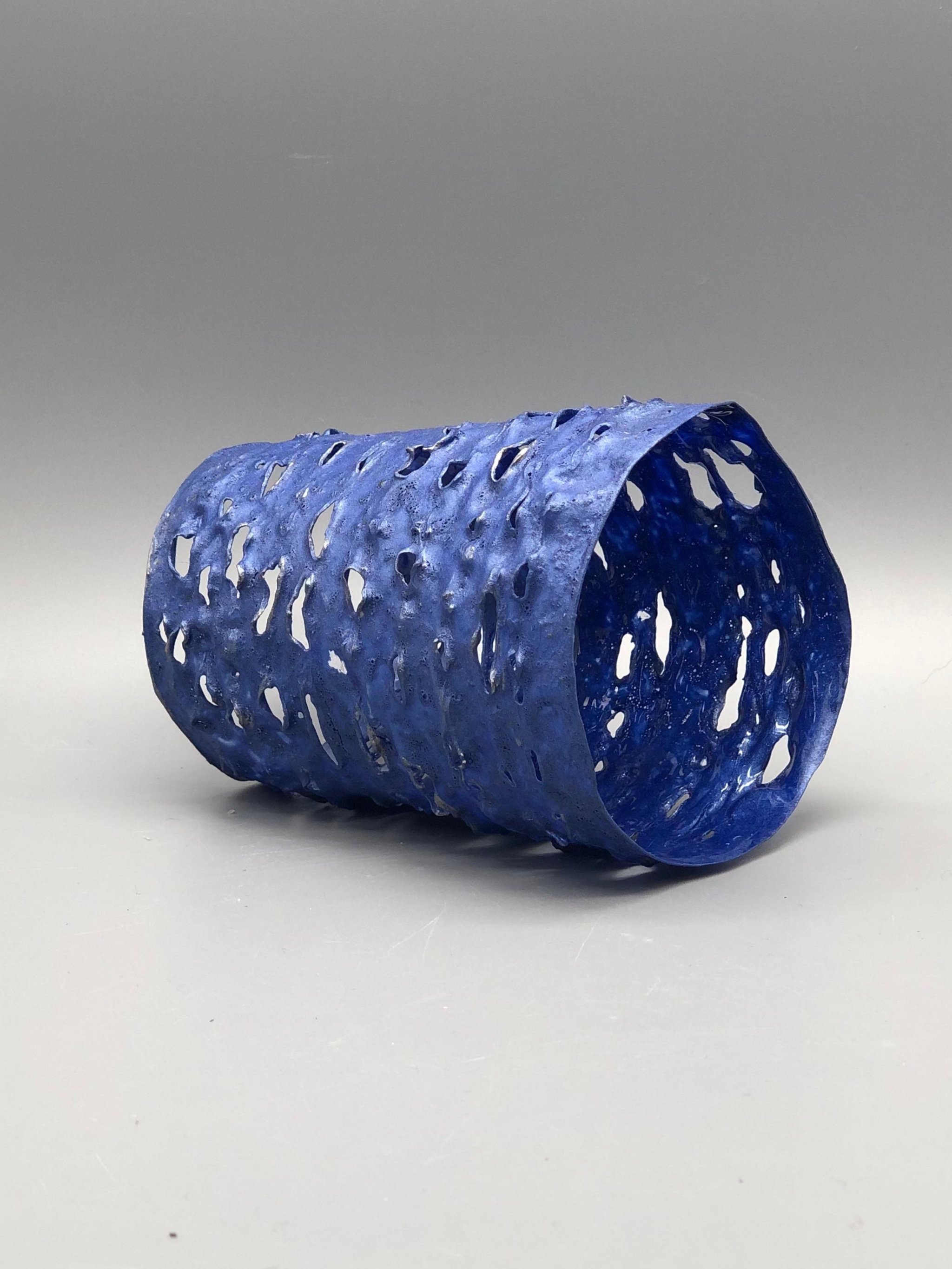 Trama Blue Metal bracelet by Giovanna Ussani, made from layered recycled plastic with perforated surface and metallic blue pigment.