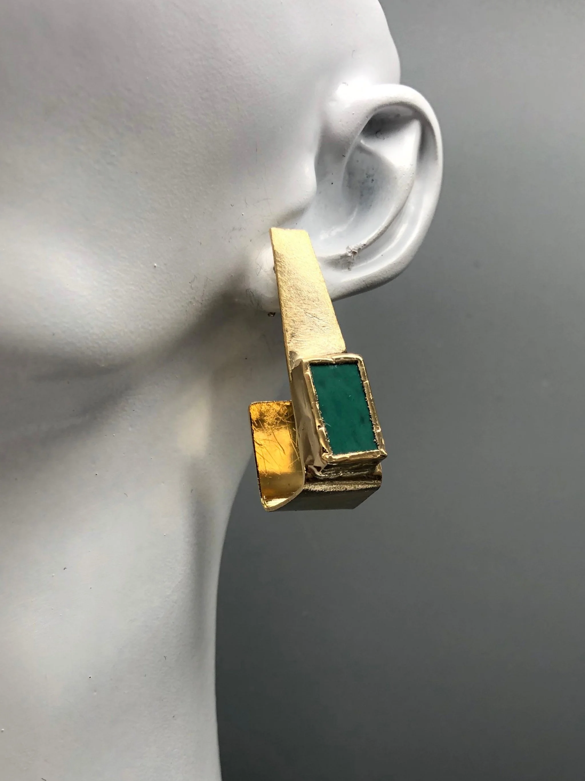 Anni Luce Risvolto earrings in 18k gold-plated brass with mint-green Murano glass, contemporary Italian designer jewellery.