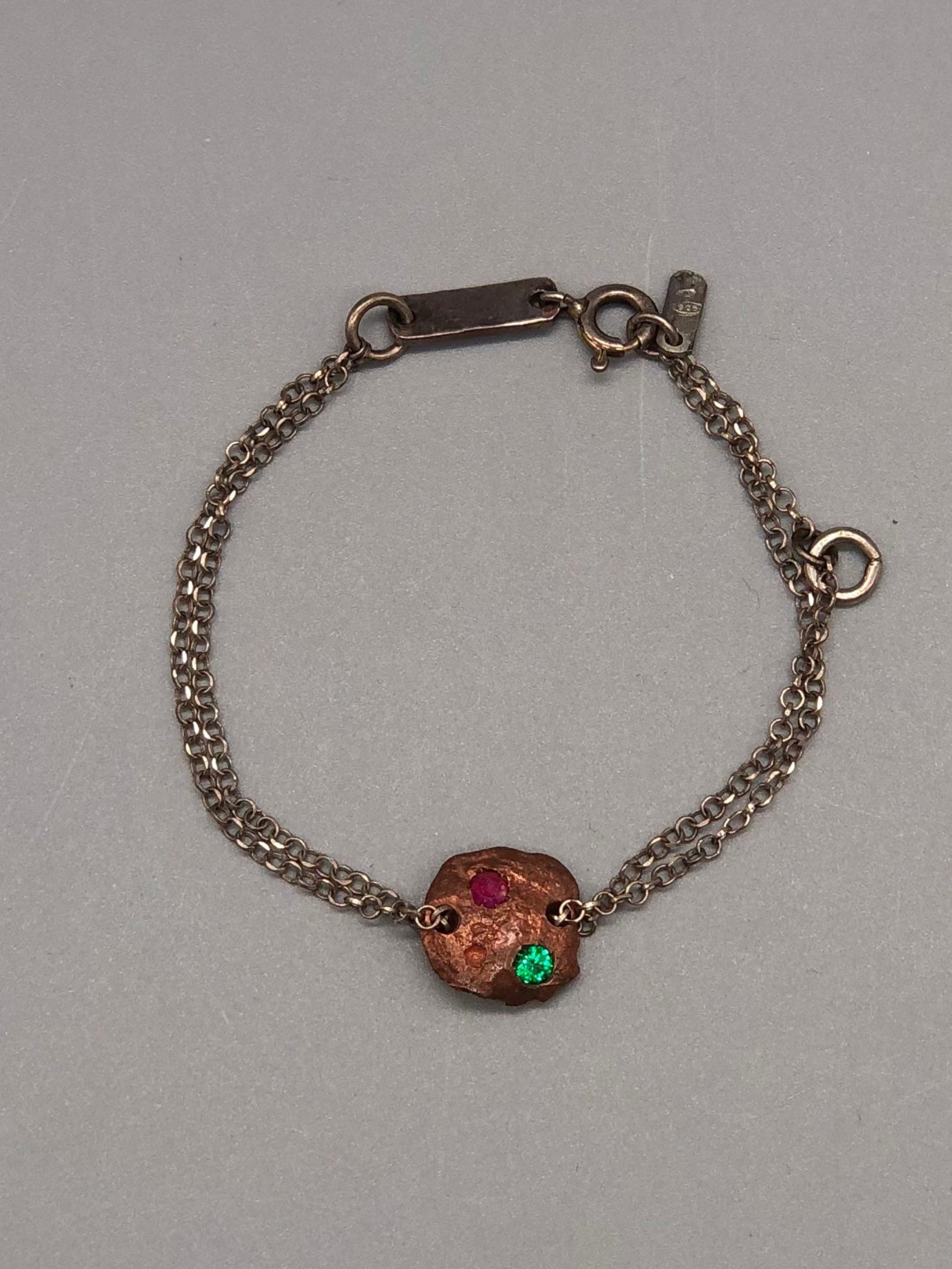 Crepundia Tracce bracelet in silver with irregular bronze element and two coloured stones.